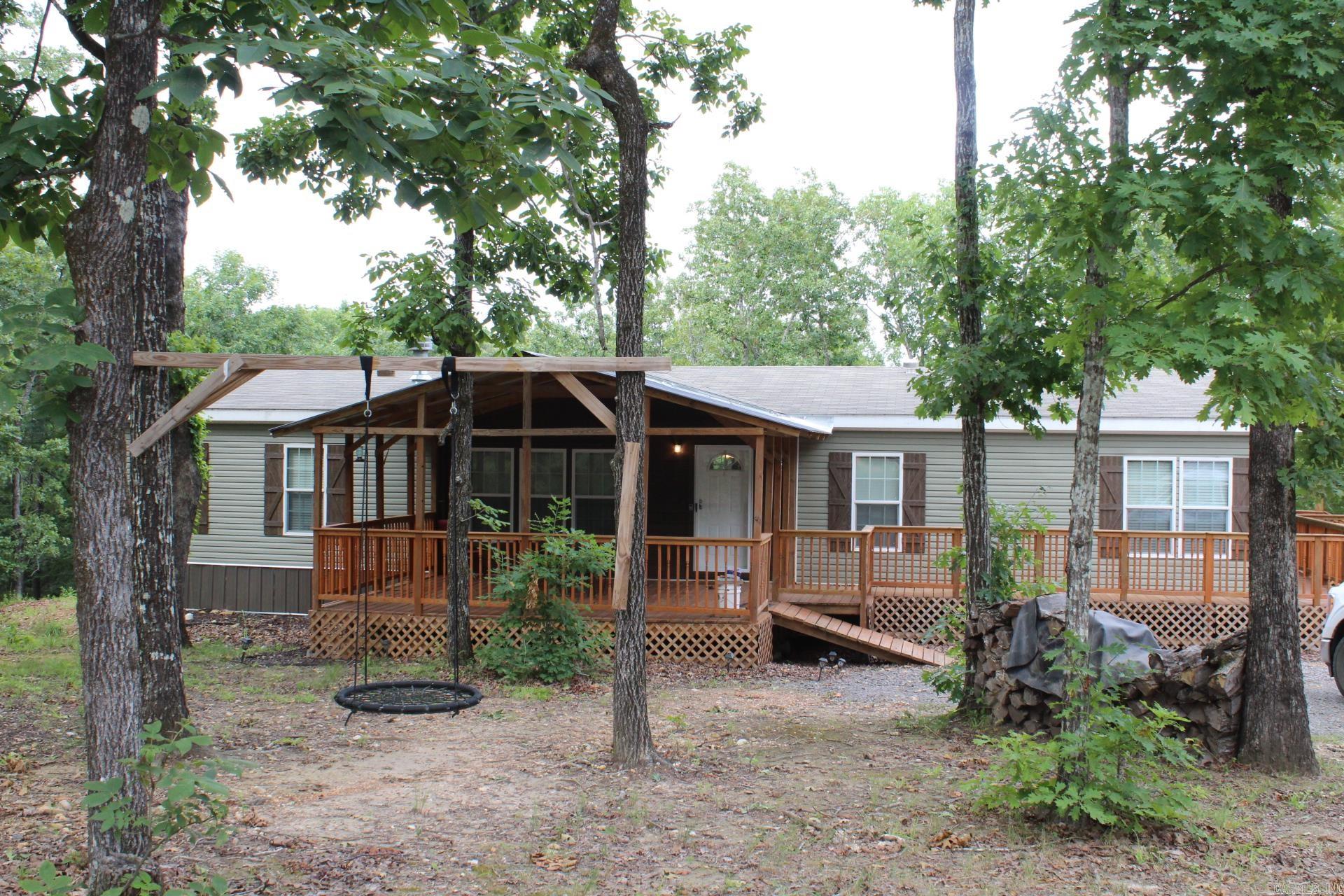 Lake House 1 Mile from Lake Greeson offers Approx. 2002 Sq. Ft. of living space. 4 Bedrooms, 2 full baths. Large kitchen with Island and lots of cabinets and laminate counter tops. Large family area features wood burning fireplace. Covered front and rear porches. Range / refrigerator/ washer/dryer conveys with sell of home. Lake Greeson is only a 15 minute walk. Narrows dam public use areas is a 11 minute drive. Crater of Diamonds State Park is a 20 minute drive.