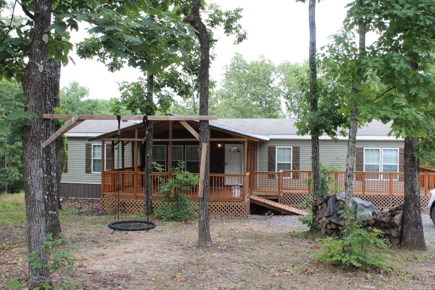 Lake House 1 Mile from Lake Greeson offers Approx. 2002 Sq. Ft. of living space. 4 Bedrooms, 2 full baths.  Large kitchen with Island and lots of cabinets and laminate counter tops.  Large family area features wood burning fireplace.  Covered front and rear porches.  Range / refrigerator/ washer/dryer conveys with sell of home. Lake Greeson is only a 15 minute walk. Narrows dam public use areas is a 11 minute drive. Crater of Diamonds State Park is a 20 minute drive.