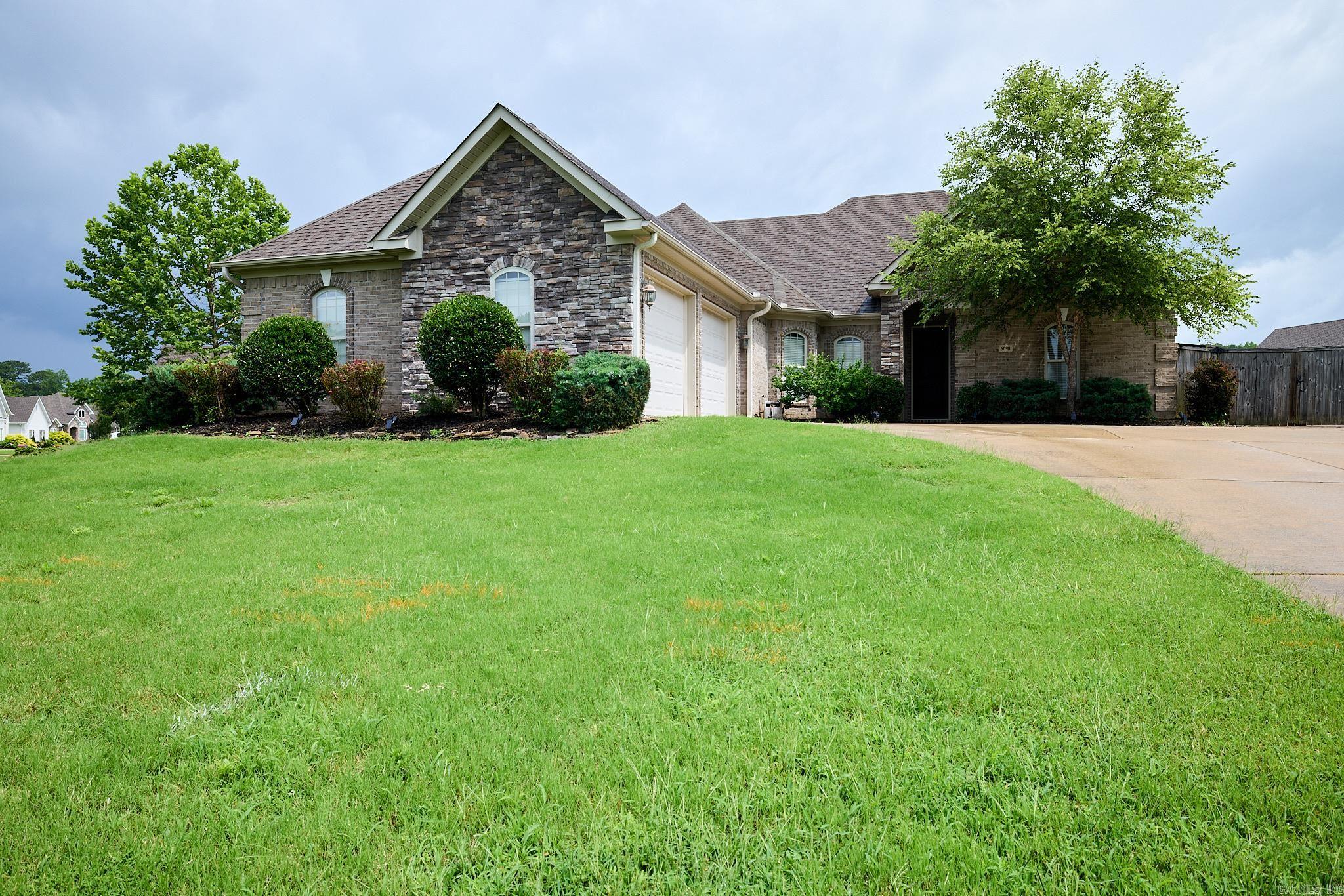 LOCATION! WONDERFUL NEIGHBORHOOD CLOSE TO SCHOOLS, SHOPPING AND INTERSTATE. YOU WON'T WANT TO MISS OUT ON THIS JEWEL! LOVELY SPLIT BEDROOM FLOORPLAN FEATURING 3 BEDROOM, 2 1/2 BATH HOME WITH A 10X25 HEATED AND COOLED SUNROOM. HOME FEATURES A SAFEROOM, 9 AND 10FT CEILINGS THROUGHOUT, PAN CEILINGS IN LIVING, PRIMARY BEDROOM AND EATING AREAS, LOTS OF CROWN MOLD, HANDSCRAPED HARDWOOD FLOORING AS WELL AS CERAMIC TILE AND CARPET IN BEDROOMS. KITCHEN FEATURES AN ABUNDANCE OF CABINETS AND COUNTERTOP SPACE WITH PULL OUT DRAWERS AND PULL OUT MIXER STAND. LOTS OF STORAGE, ALL CLOSETS FEATURE BUILT IN DRESSERS, LIVING AREA ALSO BOASTS BUILT INS, LARGE PRIMARY SUITE FEATURING A VERY LARGE CLOSET. SEPARATE LAUNDRY ROOM, PANTRY, UPDATED APPLIANCE IN KITCHEN, "JACK N JILL" BATH, FRONT LOAD TWO CAR SEPARATE GARAGE WITH STORAGE IN GARAGE, DOUBLE GATES TO BACK YARD ON TWO SIDES, EXTRA LANDSCAPING, GUTTERS ALL AROUND, TANKLESS GAS HOT WATER HEATER, FULLY FENCED WOOD PRIVACY FENCED IN BACK YARD.....AND SO MUCH MORE! REFRIGERATOR AND MOUNTED TV'S CONVEY AT NO VALUE. YOU WILL WANT TO TAKE A LOOK AT THIS BEAUTIFUL CUSTOM BUILT HOME.