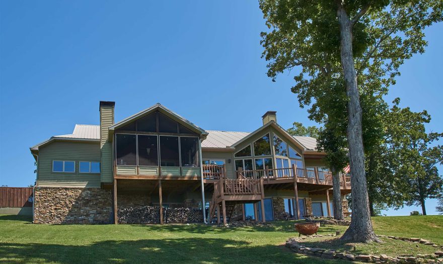 Unparalleled panoramic views greet you as you walk into this extraordinary timber frame masterpiece. Nearly all primary rooms have large windows & doors showcasing the natural beauty of Greers Ferry Lake, & merge seamlessly with the outdoor living spaces. A large screened deck with fireplace & tv, lets the gentle lake breeze blow through & is a perfect place to take a long nap. Or curl up with a good book in the library. The kitchen, dining & great room areas flow seamlessly & are ideal for entertaining The spacious kitchen is designed with multiple prep & cooking areas. The main-level primary bedroom has a private deck for enjoying coffee & beautiful sunrises. The downstairs family/rec room & two en-suite bedrooms have access to the outside, with sweeping views of the lake & mountains beyond. The huge garage has room & extra storage space for all your lake toys. Located in the much-desired Edgemont, this property is convenient to both sides of the lake by water, & close to Heber Springs, Clinton & Fairfield Bay where you will find hiking, mountain biking & ATV trails. An area boat ramp is 3 miles away. Create memories your family will never forget in this spectacular home.
