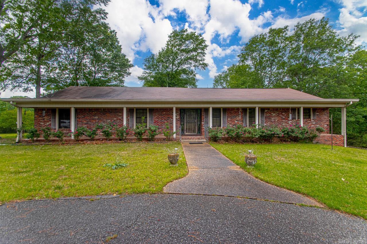 Location makes this a One of a kind property with +/- 14.5 acres that includes a pond, main home, guest house (sq. ft NOT incl), shop with electricity. Approx 1.25 miles to Walmart on Chenal and close to Pinnacle Mtn. As you enter the gate, the 1.5 acre pond sits just to your right. The main home needs updating but there is so much POTENTIAL! It has great bones. Entering the home, you will find a huge great room with fireplace. It is semi open to the kitchen and a second living space. All bedrooms and bathrooms are found on this floor. Downstairs is a private office. The master bath shower was recently redone. HVAC unit 2023, outdoor 2016. Shop with overhead door and elec. Whole house generator. Possibilty of pickleball courts on area that used to be tennis court. So much potential!! AGENTS SEE REMARKS IMPORTANT!!!