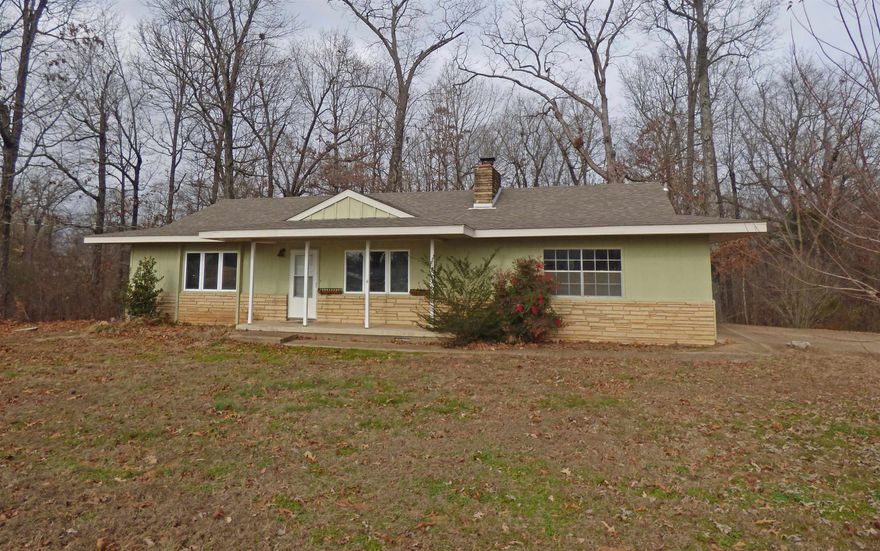 Charming Two Bedroom House in Prime Location - This house features a spacious living room with a fireplace perfect for gatherings during holidays and special occasions. Offer 2 bedrooms, 1 full recently remodeled bath, nice size kitchen with new flooring, new interior paint. A bonus room off the kitchen that would make a great sun room with views of nature and 2-car garage. All of this located across the street from Choctaw Center and close proximity to schools, banks, and Hwy 62/412. This has been a rental property and has produced good income.