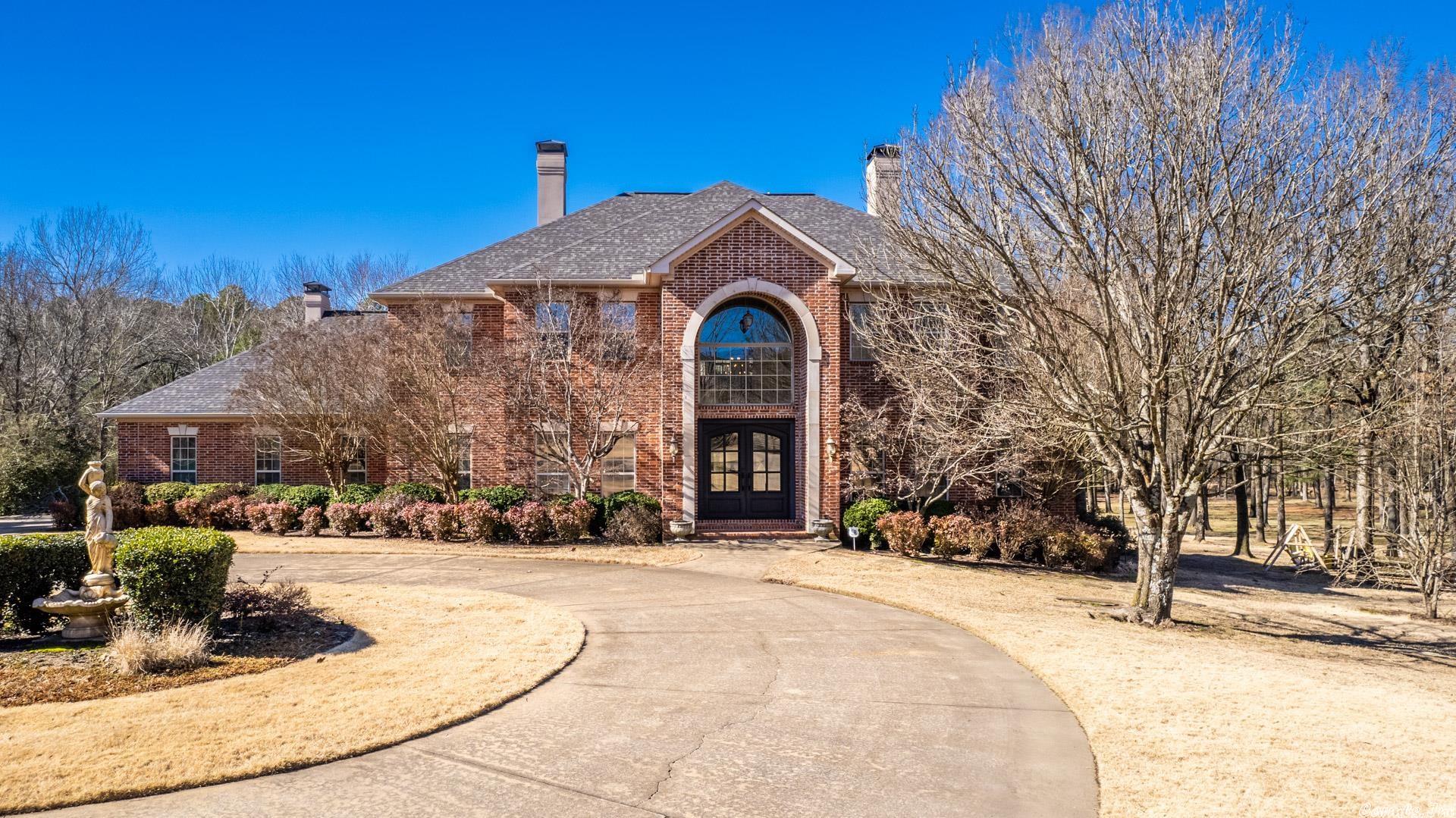 MAJESTIC describes this gorgeous home with 2.26 acres that is located in a gated community just off Hwy 10 just minutes from I430. Downstairs was totally remodeled in 2021. This home features 3 gas fireplaces, 6 burner gas stove, double ovens, automatic generator backup, gunite pool in 2017 that is heated, wireless controls, LED lighting, fountains, bubblers also with generator backup, 3 HVAC units, 2 gas water heaters, irrigated zoysia lawn, large circle drive, 3 car garage & storm cellar. Enjoy the pool & outdoors from the downstairs covered patio or tiled balcony that runs off the upstairs living area and 2 of the BRs. Huge master suite with stunning bathroom is on main level along w/formal dining, living room, office, gourmet kitchen, half bath, 2 laundry rooms, and a butlers pantry/bar w/ice maker & sink. Four other BRs, a bonus room and 3 baths are upstairs along with living area w/bar that has refrigerator & sink. Prestigious foyer with double door entry features 22 ft ceiling and a stunning staircase. Another staircase leads to the kitchen area. This is a MUST see to believe home, unique private property with city conveniences. Agents see remarks.