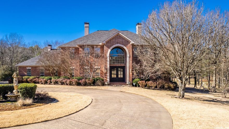 MAJESTIC describes this gorgeous home with 2.26 acres that is located in a gated community just off Hwy 10 just minutes from I430. Downstairs was totally remodeled in 2021. This home features 3 gas fireplaces, 6 burner gas stove, double ovens, automatic generator backup, gunite pool in 2017 that is heated, wireless controls, LED lighting, fountains, bubblers also with generator backup, 3 HVAC units, 2 gas water heaters, irrigated zoysia lawn, large circle drive, 3 car garage & storm cellar. Enjoy the pool & outdoors from the downstairs covered patio or tiled balcony that runs off the upstairs living area and 2 of the BRs.  Huge master suite with stunning bathroom is on main level along w/formal dining, living room, office, gourmet kitchen, half bath, 2 laundry rooms, and a butlers pantry/bar w/ice maker & sink.  Four other BRs, a bonus room and 3 baths are upstairs along with living area w/bar that has refrigerator & sink. Prestigious foyer with double door entry features 22 ft ceiling and a stunning staircase. Another staircase leads to the kitchen area.  This is a MUST see to believe home, unique private property with city conveniences. Agents see remarks.