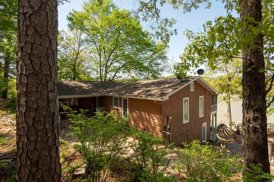Phenomenal Lake Catherine home. Main house has separate dining room, office, elevator and staircase, butler's pantry, two large living spaces with electric marble fireplaces, separate laundry room, security system, screened-in porch overlooking lake and state park, whole-house generator. Tons of storage and plenty of space for everyone to spread out.  Watch the eagles from majestic picture windows in upstairs family room or from the large screened-in porch. Professional landscaping, walking paths, lighted driveway, remodeled boat house with fireplace, half bath and kitchenette. Property also has plenty of covered parking, a treehouse with spiral staircase and workshop. Swim dock, fishing dock, covered space on the water for jet skis or kayaks. Make us an offer!!