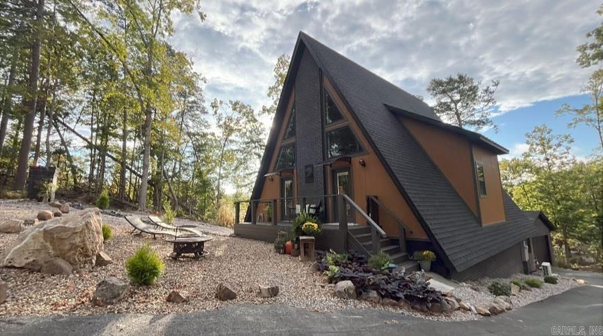 Welcome to this One of a Kind 3 story A-Frame with a detached garage/shop. This one is truly a must see to appreciate the accomodationg size and tranquility that it offers. Upon entry you are greeted with a beautiful open concept living area with 30' vaulted tongue and groove ceilings that open to the grand loft above with a stunning custom built live wood bannister, not to mention the gorgeous fireplace centered from floor to ceiling that brings the whole space together. The kitchen is a chef's dream with custom built cabinets, a 6 burner gas cooktop, top of the line SS appliances and tons of storage space. On this level you will also find the half bath/upstairs laundry room and the Primary Suite with custom details and a Primary bathroom that is timeless as it is unique with a soaker tub and walk in tile shower. The loft is a large open space with so many possibilities, it includes 1 of the 3 full size bathrooms with a walk in tile shower. The bottom level offers a complete 2nd living space with full kitchen, bathroom and laundry and over 500 sq ft of H/C partially finished space. Hot Springs Village is the largest gated residential community in the US offering something for ALL!