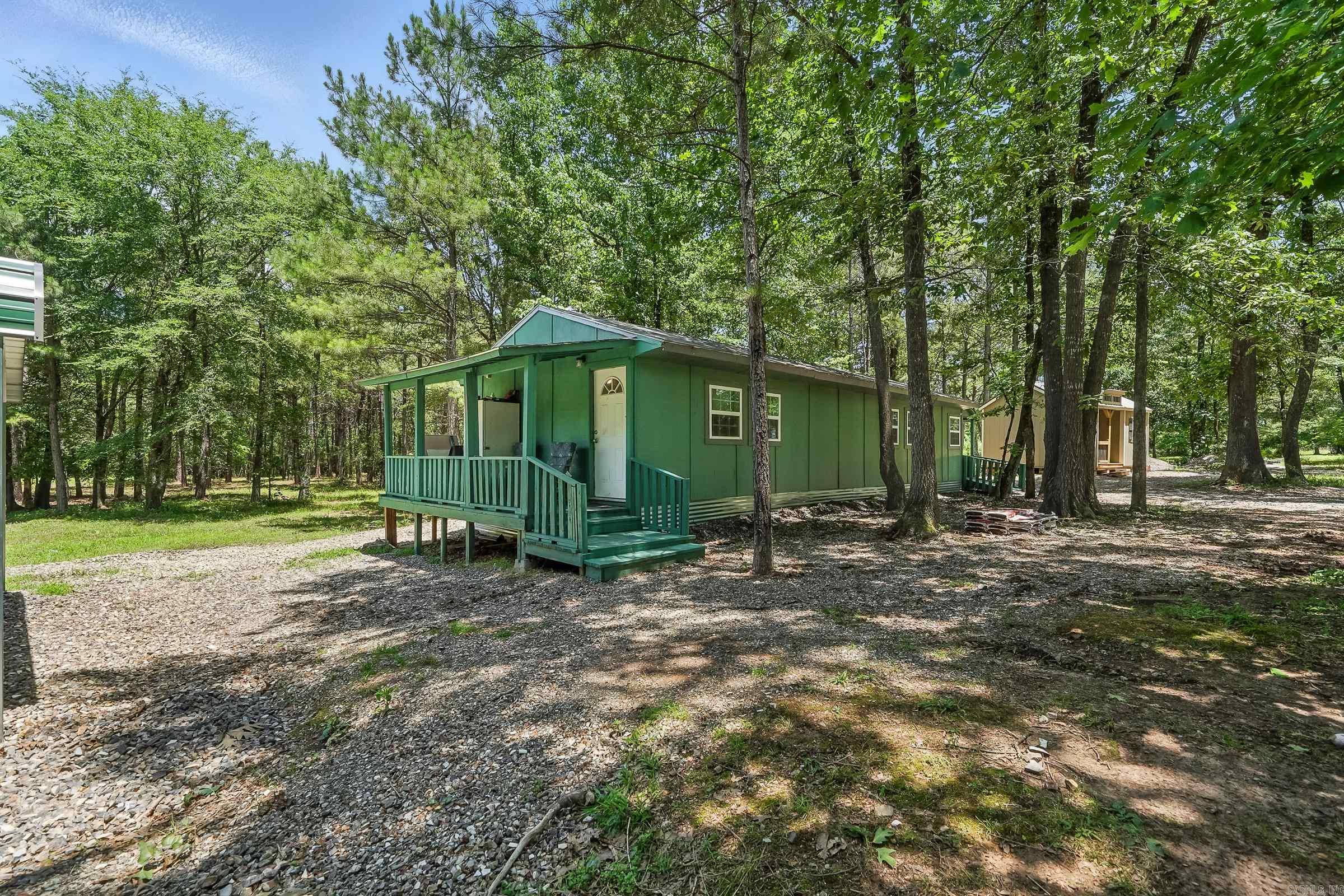 Spacious 1 bedroom, 1.5 bath cabin with laundry room and small other unfinished building that could be finished out for a second small home and all this sits on 11.3 beautiful shaded acre with beautiful trees! This home is a short drive to town on mostly pavement and you can easily ride ATV /Utvās to trails. There is also a place for a camper with electric and clean out! Lots of potential for you here! Must see it!