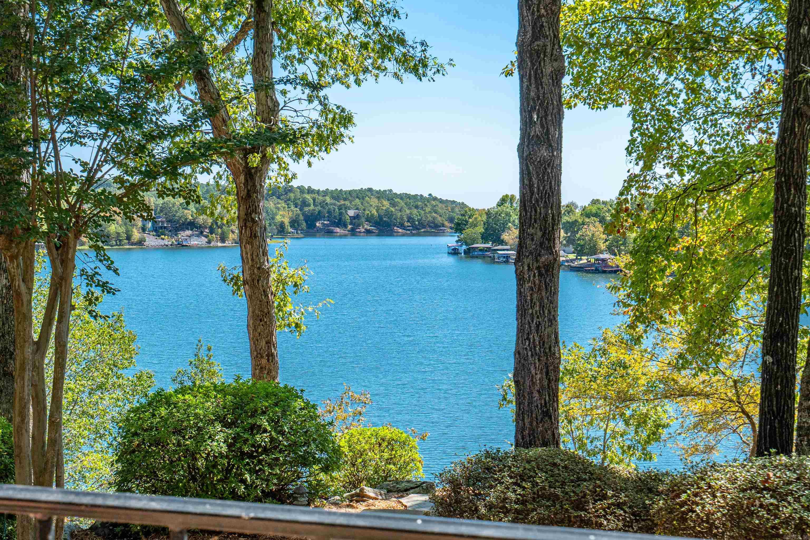 Dream retreat on the shores of Lake Balboa! Stunning waterfront home offering a perfect blend of comfort and luxury, ideal for serene lakeside living! Inviting Exterior boasts level driveway, providing easy access and ample parking. The long covered back porch is perfect for enjoying morning coffee or evening sunsets while overlooking the breathtaking lake view. Spacious Interiors with beautiful hardwood floors and volume ceilings to enhance the open and airy feel of home. The spacious kitchen features a large island, ideal for entertaining, alongside the cozy breakfast corner to enjoy meals with a view. The wall of windows fills the living area with natural light, offers stunning views of the lake, and creates a peaceful ambiance throughout. The Main Suite Retreat is a true sanctuary, featuring a large office with lake views and direct access to the porch. Perfect space for work and relaxation, allowing you to enjoy the serene surroundings. The home also includes a workshop below, providing ample space for hobbies or projects. The garden-like sitting areas offer tranquil spots for relaxation or entertaining! Private boat dock allows direct access to the lake for water activities!