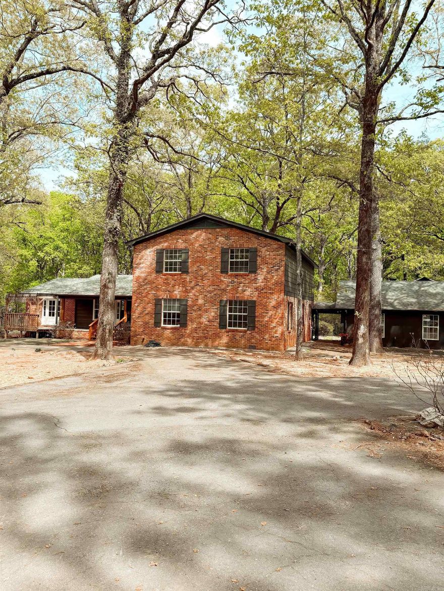 Exceptional opportunity to own approximately 5 unrestricted acres surrounded by beautiful, mature trees, creating a private, park-like retreat in a secluded, one-way-in/one-way-out setting just outside city limits that has a primary suite on both floors!!! A graceful circle drive welcomes you and offers both elegance and convenience, complemented by ample parking and dedicated RV space. This 5 bedroom, 3.5 bath 3,500 sq ft residence also features an approximately 1,100 sq ft shop and a versatile heated and cooled upstairs suite—ideal for guests, office, or flex living. Located in the Cabot School District. Extensively renovated from 2022–2026, this home has been thoughtfully updated with quality and attention to detail. Improvements include a new roof, septic system and field lines, foundation leveling, French drain, whole-house PEX plumbing, tankless water heater, new windows and exterior doors, as well as fresh exterior paint and professional landscaping completed in 2026. Schedule your showings today for this rare blend of privacy, acreage, and turnkey luxury without city restrictions!