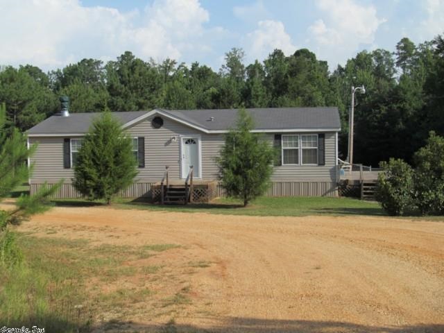 Home not visible from hwy located on 5.13 acres, circle drive, 18 wheeler accessible. Home has 2 bedrooms, 2 baths, large living room with a wood burning fireplace, kitchen/dining room comb. with work bar. Lot of cabinets & storage. Fenced area in back yard for children or pets. Landscaping a plus. The wooded area behind the house has trails cut out and have been sprayed for ticks. Trails wind through the woods for ease of hunting access. A two man dear stand to be left on the property for your enjoyment.