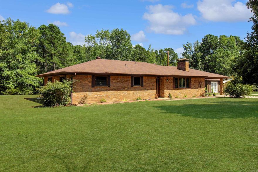 Over 8 gorgeous acres with around 500' of paved road frontage*all brick home*perfect location*3 bedrooms 2 baths*roof 1 year old*HVAC approx. 4 years old*new septic tank*16x16 sunroom on back*separate small 1-bedroom apartment*44x20 shop/RV parking*nice established pond*ADDITIONAL ACREAGE AVAILBE Some of the inside pictures of this nice home are virtually staged. This shows what a few inexpensive changes can do for this home*