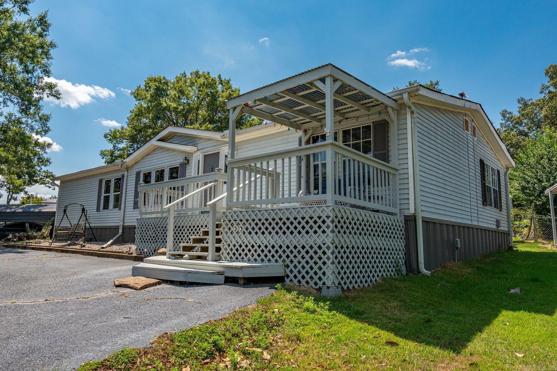 Enjoy country living in this 3-bedroom, 2-bath mobile home overlooking a stocked pond. This home offers fresh updates, including new toilets, new paint, a new water heater, and a brand-new covered deck perfect for relaxing outdoors. The property features plum and pear trees, as well as beautiful climbing roses for seasonal color. Home is being sold as-is and is not on a permanent foundation. Cash buyers only. Please provide proof of funds before showing. The roof is 2 years old.