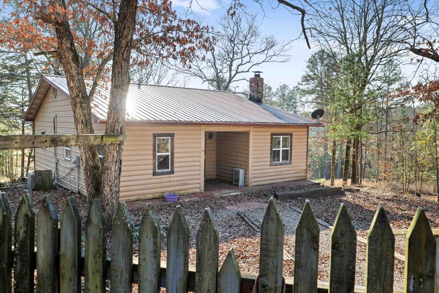Charming Country Homestead Nestled on just over 5 acres of land, this homestead property offers an opportunity to step into country living and self sufficiency that is set up and ready! Log-siding exterior invites you inside, where you’ll find a rustic, warm, inviting living room featuring a glass front wood stove-perfect for cozy nights in front of the fire. The heart of the home is a spacious, country-style kitchen, ideal for making memories. Main floor includes a large bedroom, full bath with walk-in shower, & easy access to the covered back porch. Step outside and enjoy serene views, where wildlife such as deer, turkey, and a variety of birds can be seen regularly. Downstairs, you’ll find two additional bedrooms, a full bath, and a cozy den. Outside, the homestead truly shines with its impressive features: a chicken coop, a shop, an old barn, & two expansive, fenced garden plots—currently maintained using organic gardening practices. While this home is priced to sell "as-is," it’s move-in ready and brimming with potential! A few deferred maintenance items may need attention, allowing the new owner to make it their own. Seller is motivated for a quick sale-make an offer today!