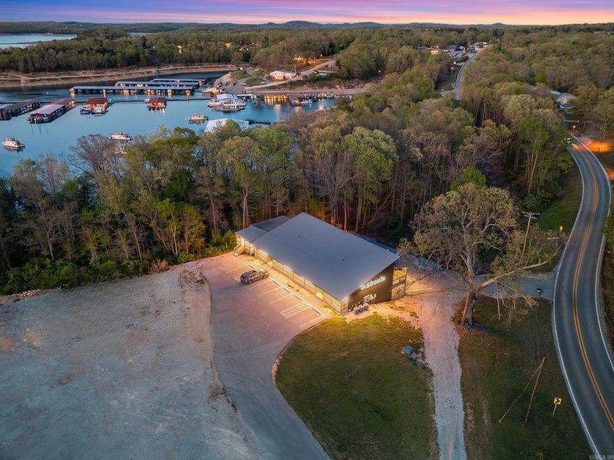 Welcome to your perfect lake getaway! This like-new 2 bedroom, 2 bath condo borders the Government Strip, offering added privacy and a natural buffer, with a seasonal view of beautiful Bull Shoals Lake and Bull Shoals Marina. Built just four years ago, this well maintained condo features an open concept floor plan designed for easy living and entertaining. The interior boasts durable luxury vinyl plank flooring throughout, a convenient laundry room, and a bright, inviting living space. Step outside and enjoy an impressive 560 square feet of outdoor living space.  Or, enjoy the common area with grills, picnic tables and restrooms. Located just a few miles from the renowned White River, famous for its world-class trout fishing, crystal-clear waters, and year-round outdoor recreation, this property offers the best of both lake and river lifestyles. Currently used as a short-term rental, this property comes fully furnished, making it truly, as an investment opportunity, vacation home, or full-time residence. Don't miss your chance to own a low-maintenance property in a prime location near the lake and river!