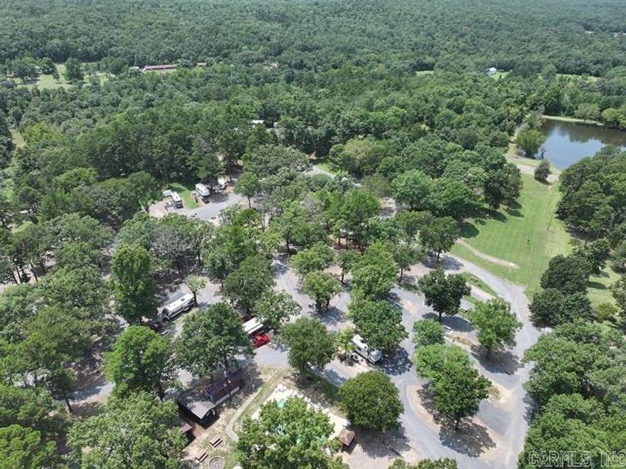 Looking to capitalize on our booming tourism sector?! Take a look at this Established, TURN-KEY, INCOME GENERATING RV Park on 31 acres in the heart of the Ouachitas! Only 10 minutes from town with highway frontage and tons of AMENITIES, this highly visible, successful park would make a fantastic investment! Boasting 70 RV spots, 7 fully furnished cabins, Multiple tent camping spots, and ongoing monthly renters, the income potential is endless with this one! Amenities include an in-ground pool, large fully stocked lake for fishing, brand new picnic area, large 40x60 shop, bathroom and shower facilities, A-Frame office building, and a playground for the kids! Each RV spot has 30 and 50 amp plug ins, picnic tables and lots of beautiful shade trees. Live on site in the well maintained double wide. Don't miss your opportunity to step into a LUCRATIVE, fully loaded commercial property in Mena! See agent remarks