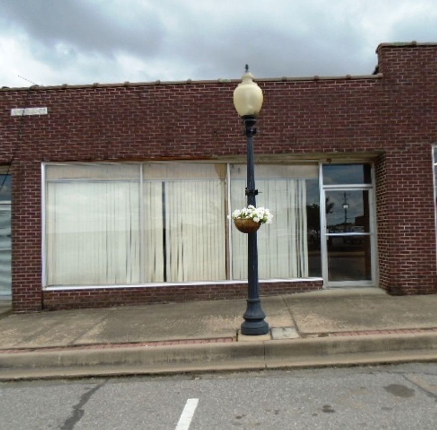 Vacant building in Downtown Morrilton. Building has CH&A, office area, 1 bathroom with sink and toilet, 12 foot ceilings & a bay door with auto garage door opener in the back. Building has some shelving but is otherwise empty. Could be used for many different things.