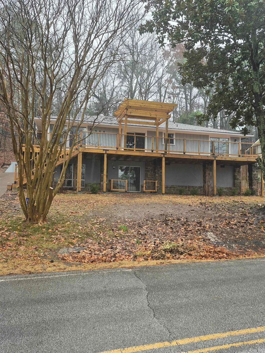 Lovely large home that has had extensive remodelling including new electrical, new appliances, one new air handler with AC and heat strip.  New waterproof vinyl plank flooring throughout and new covered deck and patio.  Open and expansive, the main floor is a delight for entertaining and includes two bedrooms and one and one half baths..  Downstairs boasts and incredible master suite with sleeping space, fireplace and den area, two walk in closets and amazing master bath.  Oversized garage and added parking are a plus.  One and a half lots for privacy make this a home you will want to check out.  Owner finance is a possibility.  Ask about terms.