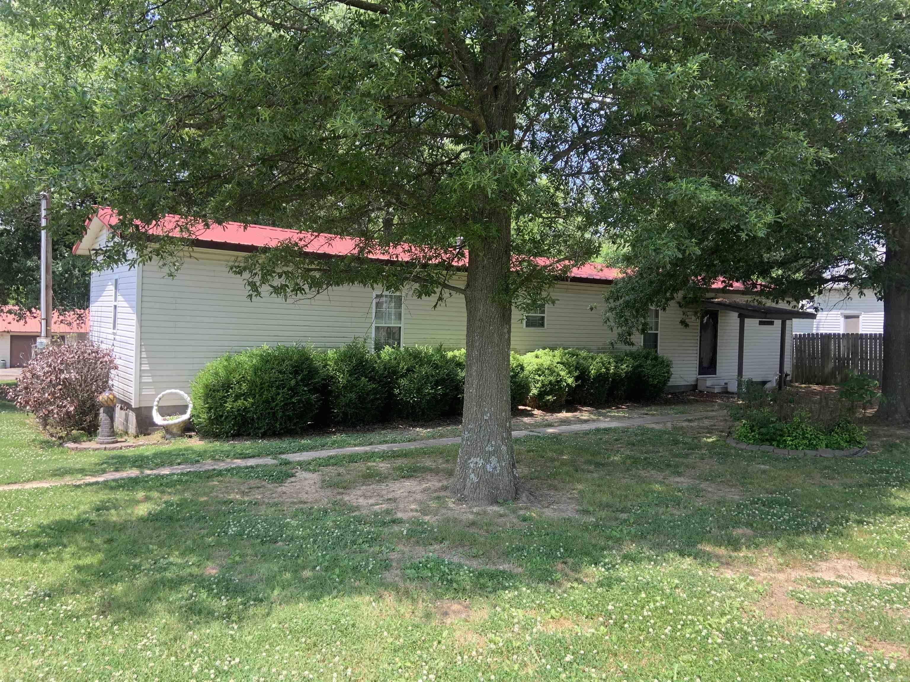 Nice Mobile Home, 2br, 2ba, nice location. SWeparate 2-two car garage/shop, concrete fllor, w/2 overhead doors and a lean too. Patio house, as it was called, small kitchen, lots of windows, gas wall heater. Storm cellar. (Old bldg on South side of property belongs to neighbor. Handicap ramp on back of Mobile Home. This is an Estate Property to be SOLD "AS IS" See Agent Remarks