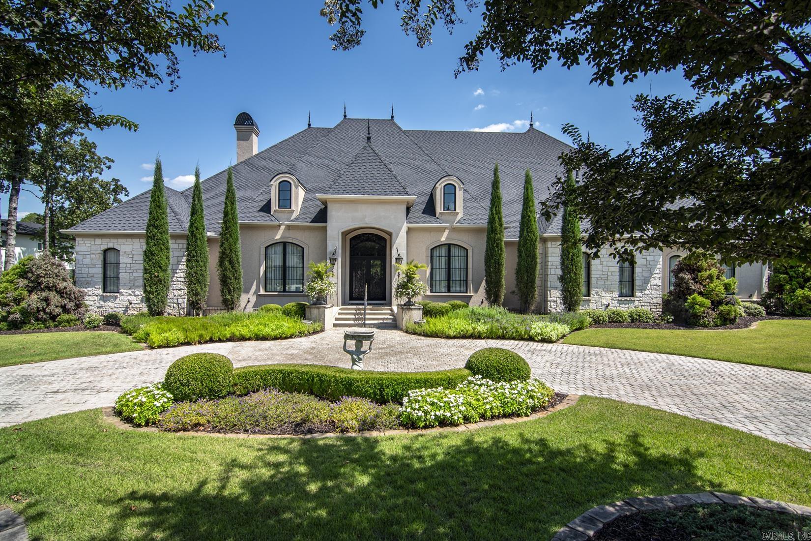 Nestled within an exclusive gated community, this exquisite home offers unmatched privacy and luxury. This custom-built, single-level residence spans an impressive 6,500 sq ft and is set on two expansive, level lots that border a tranquil creek. Designed for entertaining, the home features vast spaces perfect for hosting gatherings and creating cherished family memories. It boasts four spacious bedrooms, each with its own full bath, plus two additional half baths. The large, gourmet kitchen flows seamlessly into a grand great room, ideal for both casual family living and formal entertaining. Enjoy movie nights in your private home theater. Step outside to your personal resort-like oasis, complete with an outdoor kitchen, pool, and spa, perfect for relaxation and outdoor entertainment. A four-car garage provides ample space for vehicles and storage. Every detail in this home reflects the highest level of craftsmanship and quality, exuding sophistication, and style throughout. This residence is a rare gem, combining luxury, comfort, and an unbeatable location.