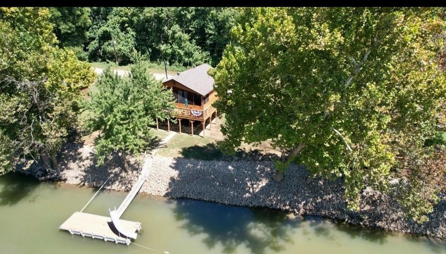 Waterfront retreat in Randolph County Arkansas! Escape to your own slice of paradise at 132 Sandy Trail between Pocahontas and Biggers, Arkansas in the bootheel of The Ozarks! This charming 784 sq ft. cabin offers the perfect blend of cozy comfort and stunning natural beauty on the pristine Current River with its own boat dock. Property Highlights include: 2 bedrooms, 1 bathroom - ideal for weekend getaways or year-round living. Private boat dock for fishing, swimming, and water recreation. Spacious .55-acre lot (2 lots total) with river frontage. Peaceful waterfront setting perfect for relaxation and outdoor activities with screened in front porch overlooking the water. Wake up to the gentle sounds of flowing water and spend your days fishing from your own dock, kayaking the Current River, or simply enjoying the tranquil riverside atmosphere. The cabin's efficient layout maximizes every square foot while the generous lot size provides plenty of outdoor space for entertaining, relaxation or future expansion. There is also a separate patio/deck for cookouts or bonfires in the evening. Parking can be done below the cabin for shelter or used for boat storage.