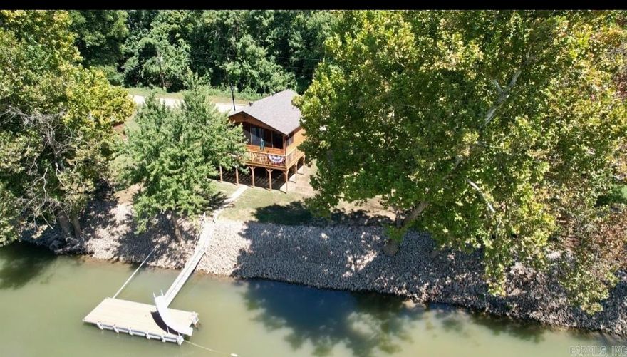Waterfront retreat in Randolph County Arkansas! Escape to your own slice of paradise at 132 Sandy Trail between Pocahontas and Biggers, Arkansas in the bootheel of The Ozarks! This charming 784 sq ft. cabin offers the perfect blend of cozy comfort and stunning natural beauty on the pristine Current River with its own boat dock. Property Highlights include: 2 bedrooms, 1 bathroom - ideal for weekend getaways or year-round living. Private boat dock for fishing, swimming, and water recreation. Spacious .55-acre lot (2 lots total) with river frontage. Peaceful waterfront setting perfect for relaxation and outdoor activities with screened in front porch overlooking the water. Wake up to the gentle sounds of flowing water and spend your days fishing from your own dock, kayaking the Current River, or simply enjoying the tranquil riverside atmosphere. The cabin's efficient layout maximizes every square foot while the generous lot size provides plenty of outdoor space for entertaining, relaxation or future expansion. There is also a separate patio/deck for cookouts or bonfires in the evening. Parking can be done below the cabin for shelter or used for boat storage.