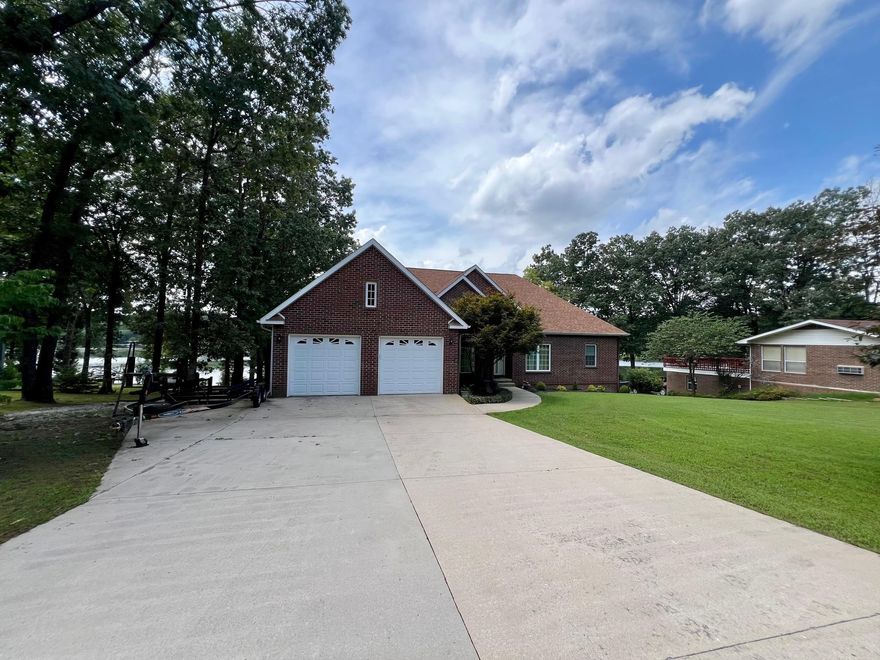 Consider this large well-maintained lakefront home with  4-bedrooms, 3  1/2-bathrooms in about 4,632 s.f. m/l. This two-level residence has comfort and style with its semi-open floor plan with neutral colors, lots of windows and updated flooring.  Enjoy morning coffee and evening sunsets on the deck overlooking the lake. The covered dock provides a convenient launching  for all your water activities. This property is more than just a house – it's a lifestyle choice and a hard one to top. The combination of updates, natural light, and prime lakefront positioning creates an opportunity that's both practical and enjoyable. Your search for the perfect blend of comfort, convenience, and natural beauty can end here. Main level features include an attached 2 car garage, laundry room, gas log fireplace in the living room, formal dining room and a study. The family room on the lower level easily accommodates a pool table. If space for a hobby/crafts/music is a requirement-look no further. There is a shop room and lots of storage space on the lower level and an electric chair lift on the stairs. The flat lot even includes a fenced backyard to corral those 2 & 4 legged family members.