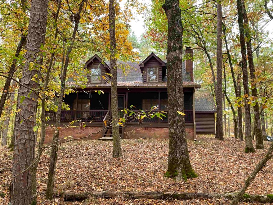 Beautiful cabin in the woods that has space for all your family and friends located at Mountain Harbor Resort.  This furnished, 3 bedrooms, 2 bath, approx. 2,432 sq ft home has the open concept that makes hanging with your family and friends so easy. The large living area has a wood burning fireplace and is open to the kitchen which already has updated appliances and countertops. The sunroom is located off the kitchen with views of the forest and the wildlife that feed at the included deer feeder.  Updates to the home include paved driveway, interior paint, exterior paint, bathrooms, enlarged back deck, screened front porch and more!  Included with the home are 2 extra lots to ensure your privacy for a total of 4.66 +/- acres AND it backs up to the national forest.  Call today for your private showing!