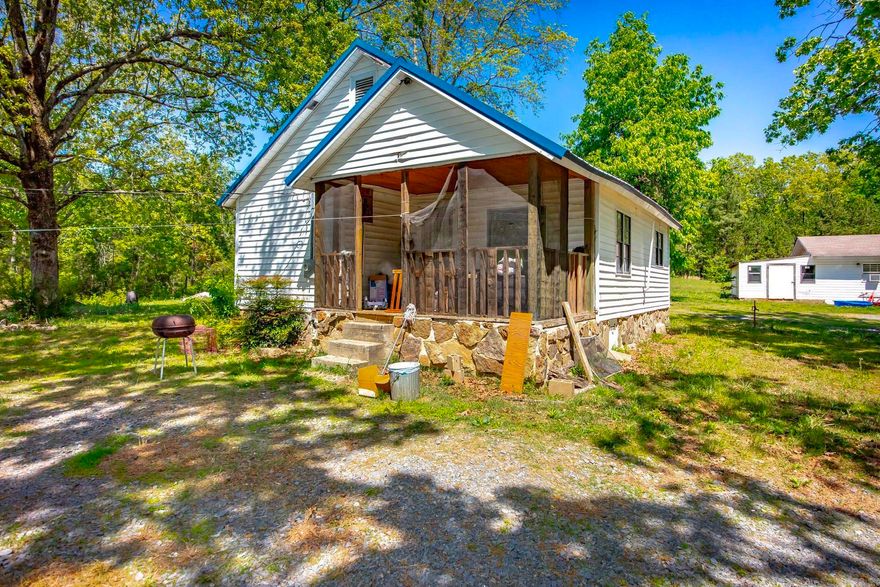 Situated on approximately 5 acres within city limits, this versatile property offers the perfect setup for a primary residence with accessory units — ideal for multi-generational living, guest space, or potential rental income. The main home features existing ductwork for central heat and air (currently utilizing window units), a remodeled bathroom, updated porch, and a roof approximately six years old. In addition to the main home there is a separate building with two efficiency apartments and a 3rd building with the unfinished unit. Two units are completed and currently occupied, while the third unit is partially finished with electrical and plumbing already in place, offering the opportunity to expand living space or future income potential. Each unit is separately metered for water and electric, providing flexibility for a variety of uses.  All structures will require some repairs and TLC, making this a great opportunity for buyers looking to customize a property to fit their needs,  whether for personal use, extended family, or supplemental income. For showing instructions and additional details please see agent remarks.