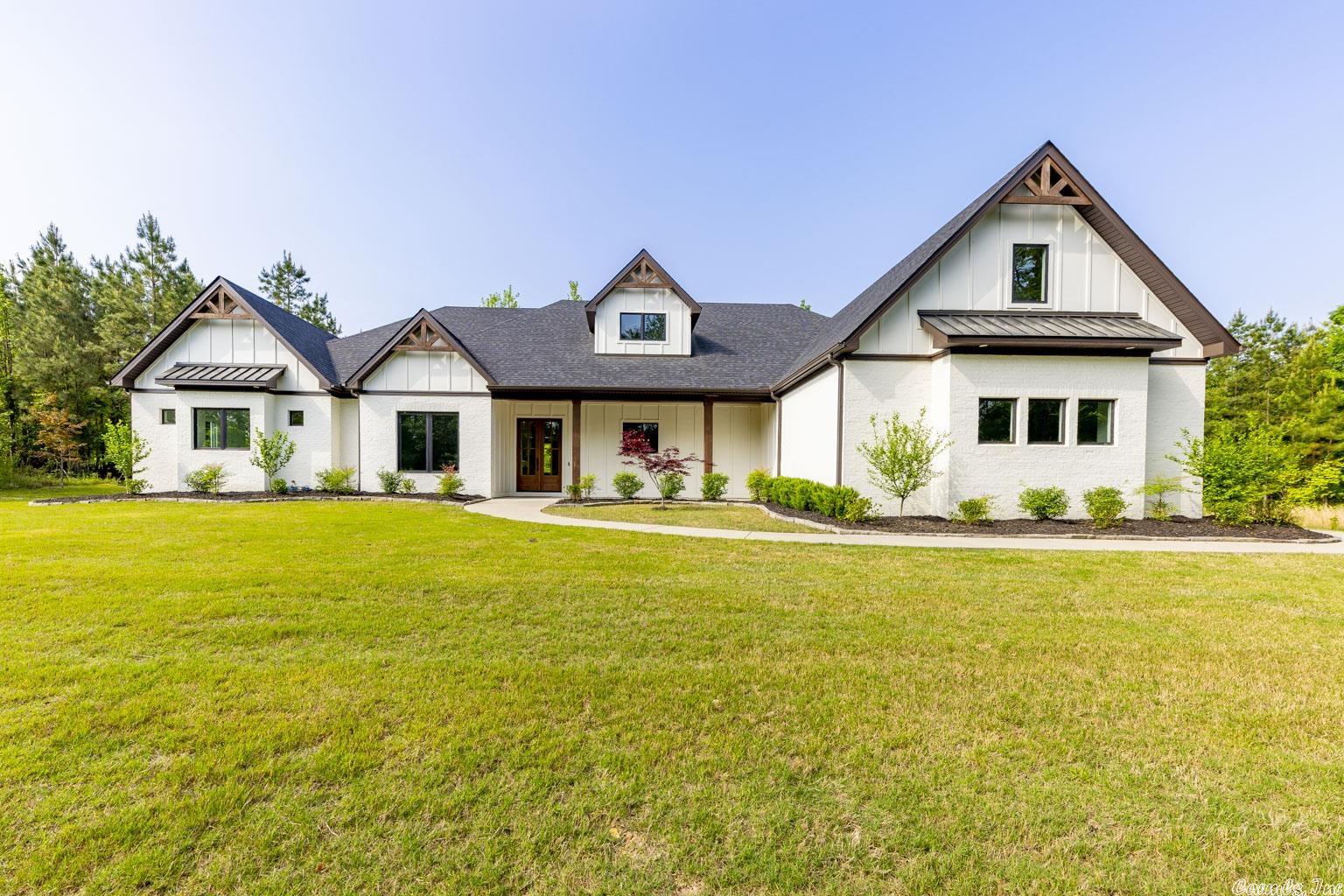 This is a Rare find in the private and gated Glennwood Springs Subdivision. This beautiful home sits on 3 wooded acres with mature trees for privacy that surrounds the home including the fenced backyard or enjoy the cozy fireplace in the lovely screened in patio. This open floor plan home with an abundance of windows to allow ample natural lighting throughout is the one you have been waiting for. The main living area boasts a stunning gas fireplace with plenty of space and custom surround sound for your entertainment needs. The kitchen is to die for and is meant for cooking and entertaining with marble countertops and high end stainless steel appliances with a large walk-in pantry.  This home offers 4 bedrooms and 3 full bathrooms with an optional 5th bedroom/office with ensuite bathroom access. The Primary suite is designed to be the perfect respite offering an oversized bedroom with private, covered outdoor access and a lovely spa-like bathroom. In addition the home offers a full security system with cameras and motion sensors, a sprinkler system, underground fiber optic HSI. Schedule your tour today!