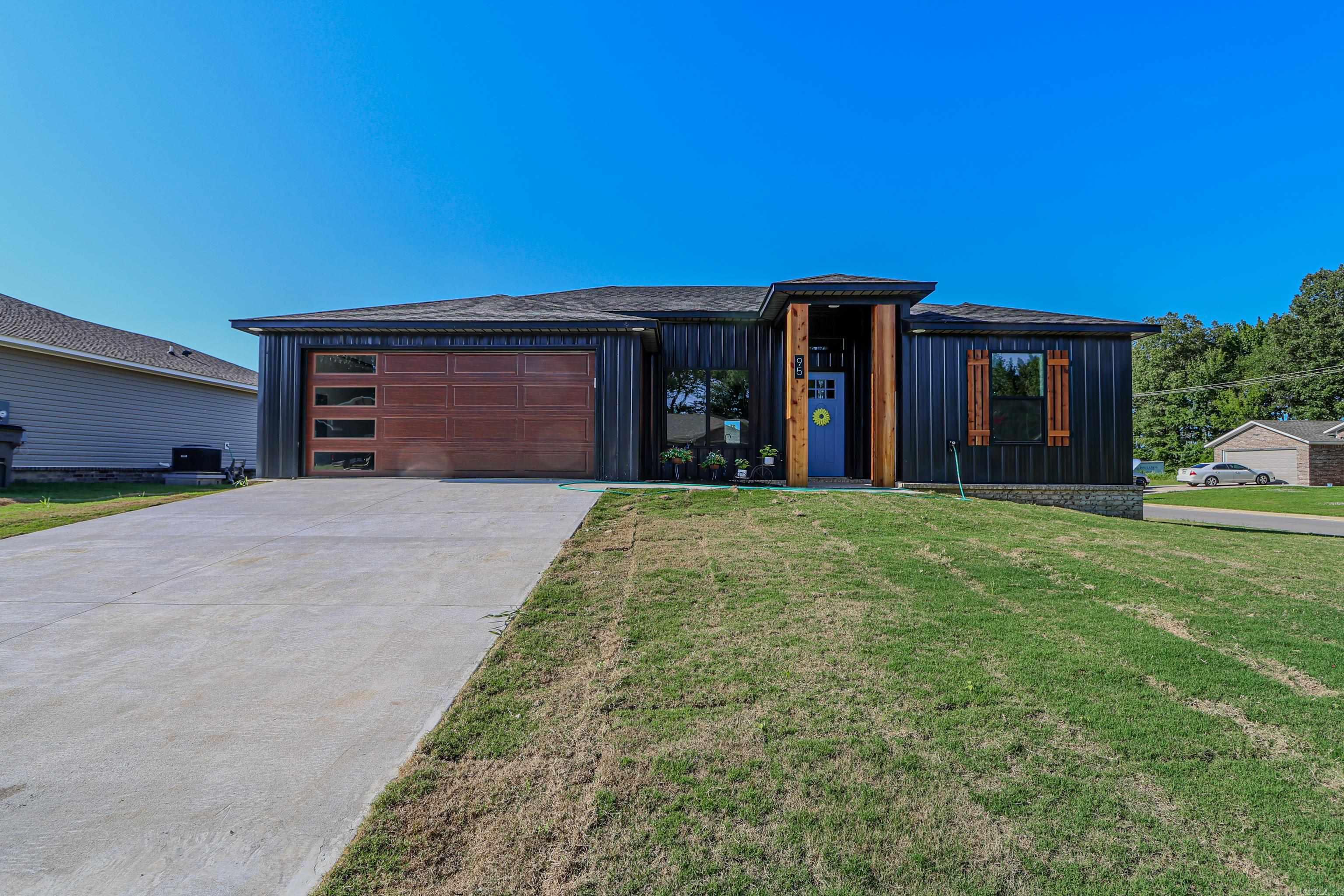 Discover modern living with this exquisite barndo style home, offering 4 bedrooms and 2 baths across 1,568 sqft +/- of expertly designed space. This energy-efficient, all-electric home combines sustainability with comfort, ensuring lower energy costs and a smaller carbon footprint. Step into a beautiful kitchen highlighted by an accent-colored island, perfect for both everyday meals and entertaining guests. The primary suite is a retreat with its spacious walk-in closet and luxurious walk-in shower. The home's flexible layout includes a versatile fourth bedroom that can be easily transformed into an office, sunroom, or formal dining room, catering to your lifestyle needs. Enjoy the airy living room with its impressive 10' ceilings and transom windows that flood the space with natural light. Relax on the covered porch while taking in the charm of your corner lot, which is not located in a flood zone for added peace of mind. The property is fully serviced with all utilities, including high-speed fiber internet provided by PMU. To make this dream home even more accessible, the seller is offering up to $7,000 to cover closing costs or to buy down your interest rate.