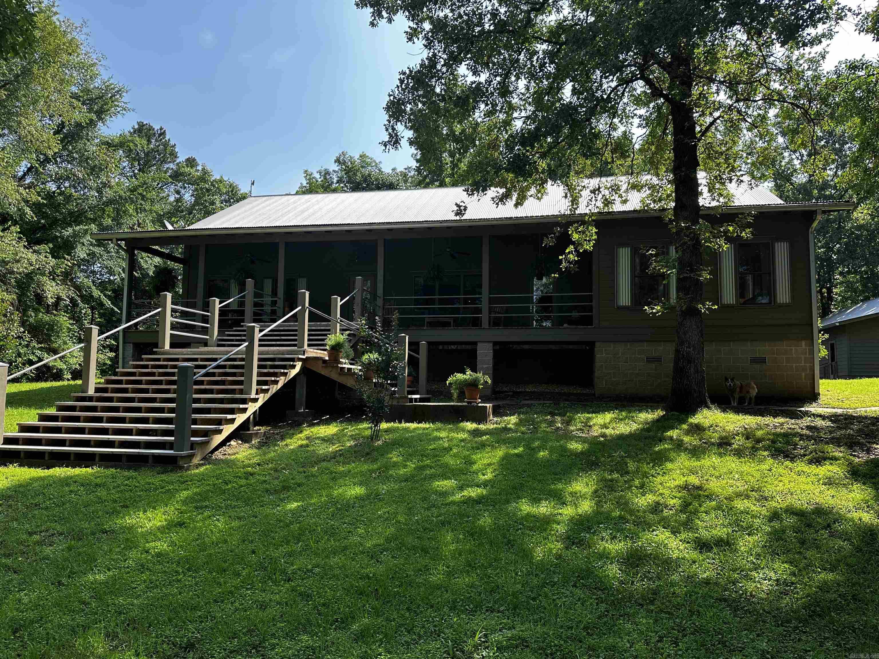 Nestled on 87 acres of serene timberland, this modern vernacular farmhouse blends traditional charm with contemporary flair. Embracing the essence of the area's architectural heritage, this home has a sleek and updated aesthetic while maximizing functional spaces.Features include durable cementitious siding, galvalume corrugated roofing, and seamless gutters. The detached 3-car garage/shop adds versatility, providing ample space for vehicles, tools, and hobbies. You'll love the views of the 7 acre pond from your front porch.