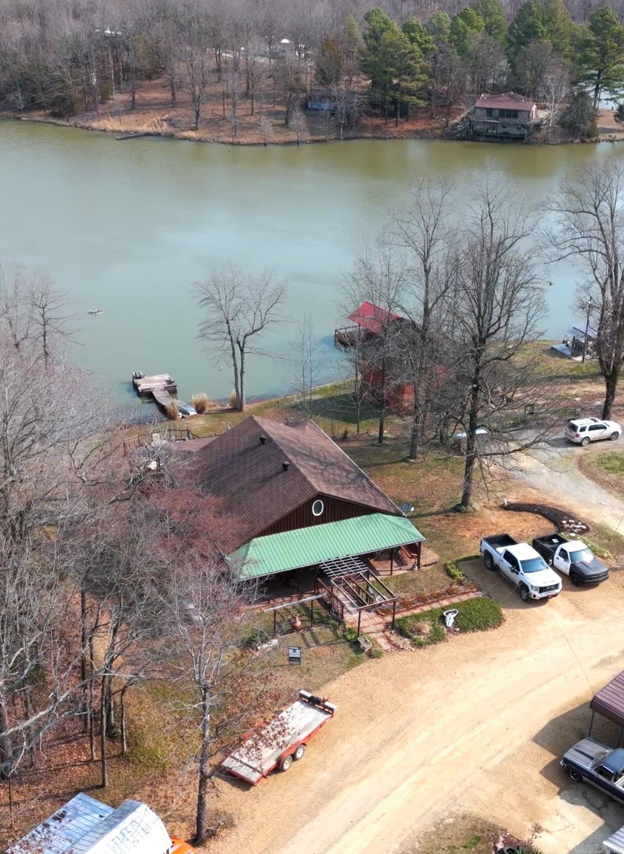 This peaceful property is a 2BR, 1BA, 2730 sq. ft. home sitting on 1.62 +/- acres sitting on one of the highest points overlooking Frie Lake. This peaceful property has an open floor plan allowing for a smooth transition from the kitchen area to the dining room and living areas. The back deck has a relaxing ambiance as you sit and watch the wildlife in the surrounding woods and overlooking the lake. The upstairs level offers new Anderson'' windows throughout. The downstairs is a full walkout basement offering an amazing large room for entertaining. A beautiful live edge wood bar area and extra living space. The property has a 30x46 shop with 12 ft. ceilings and is heated/cooled with a bonus Atlas'' 9,000 lb lift and an air compressor that is plumbed with air drops throughout. There is also a small Storage Shed with an awning for extra storage space.