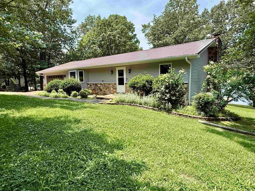 This completely remodeled 4-bedroom, 3-bathroom home is situated on approximately 1 acre along the south side of the beautiful 645-acre Crown Lake. It resides in the South Shore subdivision on lots 20 and 21 of Horseshoe Bend, Arkansas. With a brand-new metal roof and thoughtful updates throughout, this home is move-in ready and ideal for year-round living or a relaxing vacation getaway. Inside, you’ll find two bedrooms on each level, including spacious master suites both upstairs and in the basement. The large kitchen features a breakfast bar and opens to a light-filled living area, where expansive windows capture stunning lake views. Step out onto the lakeside back porch and enjoy peaceful mornings or vibrant sunsets over the water. Conveniently located just minutes from the heart of town, you’ll have easy access to local shops, restaurants, and amenities. Whether you're looking for a permanent residence, or a weekend vacation home, this Crown Lake home can be yours—all for $434,900.