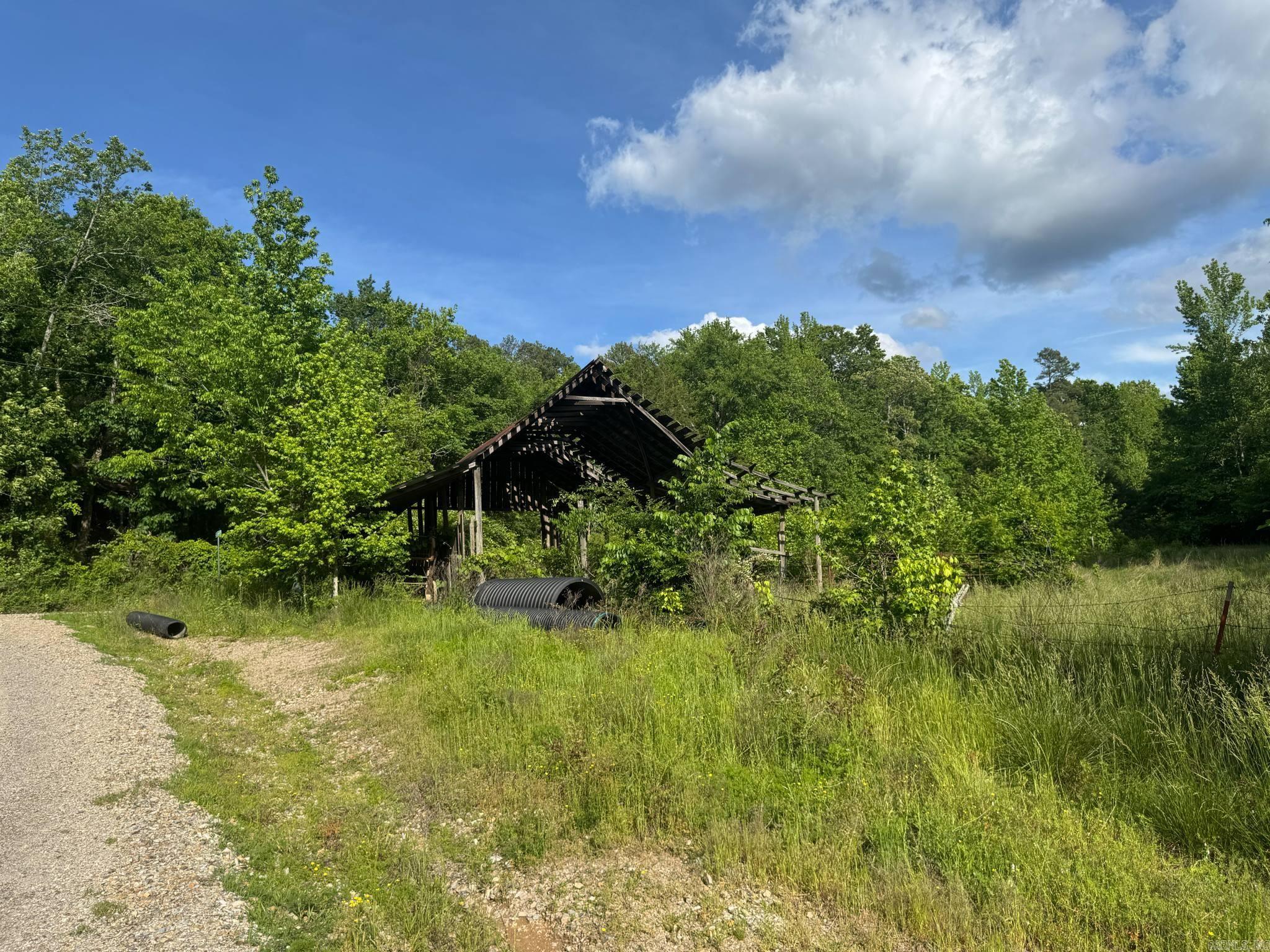 Tucked away in the quiet beauty of Montgomery County, this 9.32-acre tract offers a peaceful retreat with a blend of natural features and practical potential. The land is mostly wooded, providing privacy and a serene atmosphere, with a small clearing already in place—perfect for a future home or getaway cabin. Enjoy slight mountain views and the soothing sound of a creek that passes nearby, running through a culvert along the gravel road that provides easy year-round access. The property is partially fenced and located just 2.8 miles from the Ouachita River, making it a great spot for nature lovers, weekend adventurers, or those looking to build in a quiet, rural setting without being too far off the beaten path.
