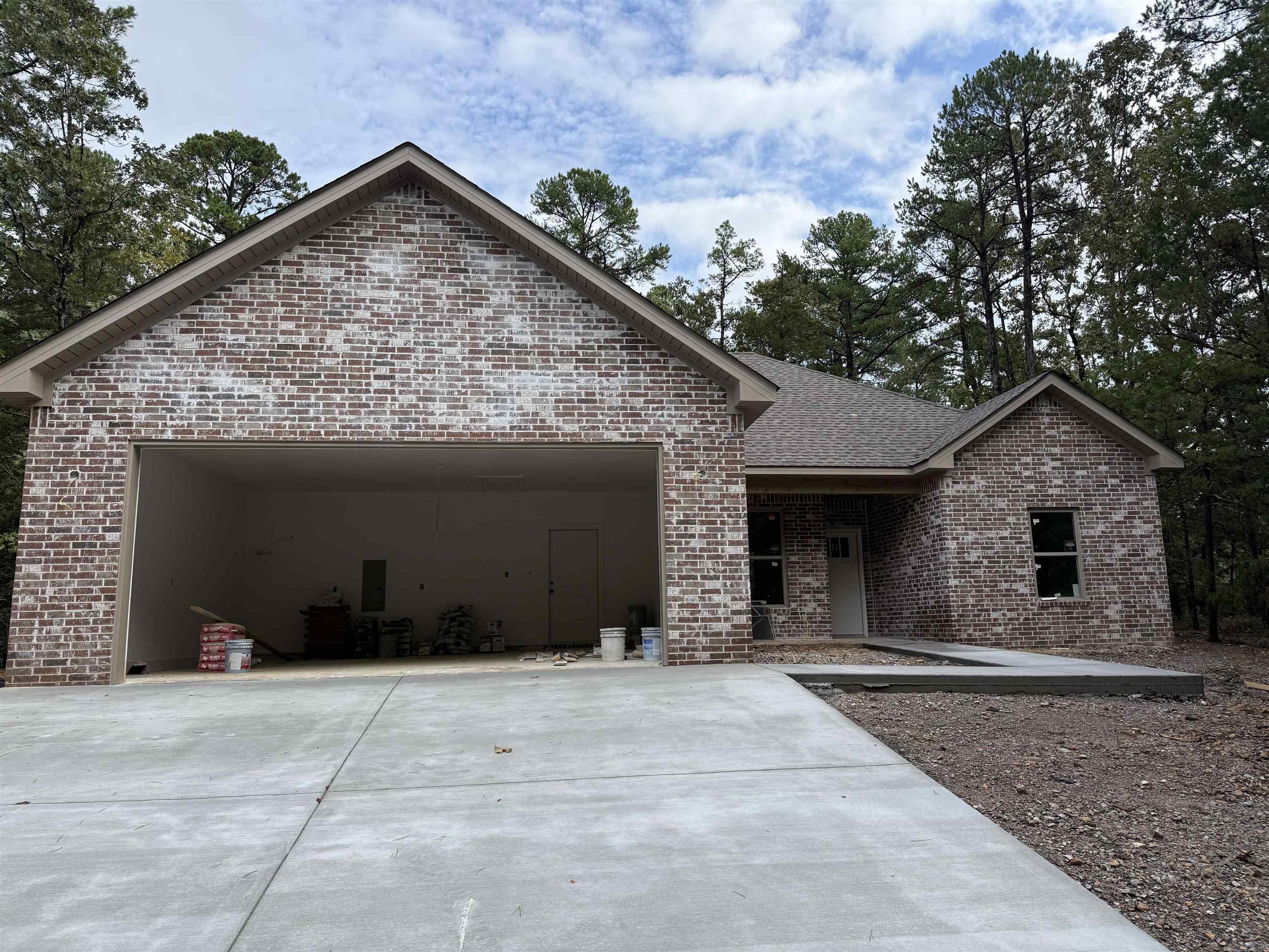 Discover luxury in this new construction home nestled in the prestigious Hot Springs Village golf community! This stunning 3-bedroom, 2-bathroom residence sits on a flat, tree-lined lot, offering privacy and natural beauty. The oversized 2-car garage provides ample space for vehicles and storage. Inside, enjoy a custom-designed kitchen with top-of-the-line stainless steel appliances, sleek countertops, and a large island perfect for entertaining. The open-plan living area features a cozy fireplace, soaring ceilings, and high-end finishes throughout, creating a warm and inviting atmosphere. With access to world-class golf courses and serene community amenities, this home is ideal for those seeking modern comfort and an active lifestyle. Move in and start living your dream today!