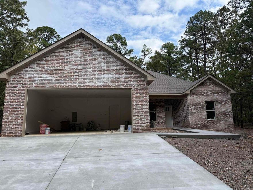 Discover luxury in this new construction home nestled in the prestigious Hot Springs Village golf community! This stunning 3-bedroom, 2-bathroom residence sits on a flat, tree-lined lot, offering privacy and natural beauty. The oversized 2-car garage provides ample space for vehicles and storage. Inside, enjoy a custom-designed kitchen with top-of-the-line stainless steel appliances, sleek countertops, and a large island perfect for entertaining. The open-plan living area features a cozy fireplace, soaring ceilings, and high-end finishes throughout, creating a warm and inviting atmosphere. With access to world-class golf courses and serene community amenities, this home is ideal for those seeking modern comfort and an active lifestyle. Move in and start living your dream today!