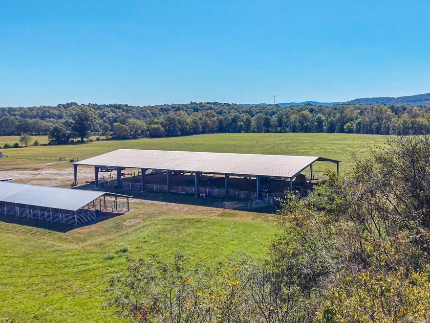 This premier working cattle and horse ranch encompasses 185.94± acres of beautiful, improved pastureland with exceptional facilities for both ranching and equestrian events. The crown jewel is a 100’x200’ covered steel truss arena with LED lighting, sound system, laser barrel and pole markers, announcer’s booth, and four cattle holding pens.  A Snack Shack with covered patio and two restrooms adds convenience for guests and participants on one side of the arena. On the other side, the 24-stall covered barn offers power, water, and dusk-to-dawn lighting, while 18 RV hookups provide 50, 30, and 110 amp service with water at each site.  A second barn includes 11 stalls (9 under roof), wash bay, tack and feed rooms, office with restroom, machine shop, and a round pen.  Eight fenced pastures feature Ritchie automatic waterers in place, filled from a well that has never run dry, as well as ponds, creeks, hay pastures, dry lots, and doctoring chutes.  The property extends to the center of the South Fork of the Ouachita River, offering scenic views, canoeing, and swimming.  A new survey is complete and the property is ready to enjoy or operate immediately.