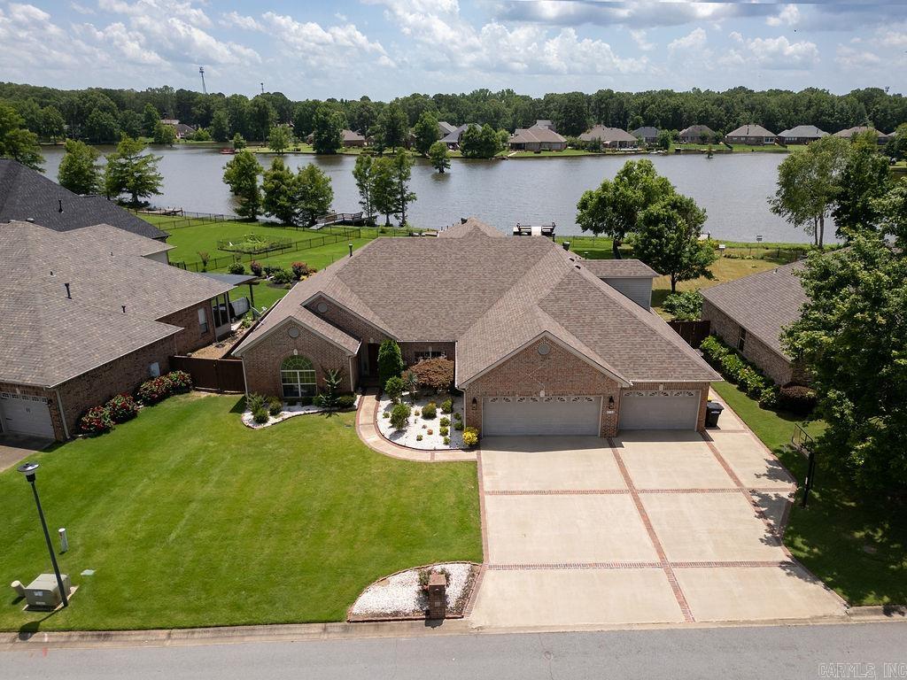 Lakefront Living - Nestled in the heart of Sherwood on Indianhead Lake this gorgeous home has everything you need and then some!! You'll love the large living room with views of the pool and lake, plus a sunroom that's perfect for relaxing and entertaining year-round. There's a formal dining room as well as an eat-in kitchen with breakfast bar. Additional amenities include a private theater room, fireplace, large walk-in closets (2 of which are in the primary bedroom), 3 zoned units, 16x32 pool with oversized concrete deck, covered balcony, four-car garage wired for electric car charging station, tons of storage including a large heated and cooled garage storage room, and BOAT/FISHING DOCK!!