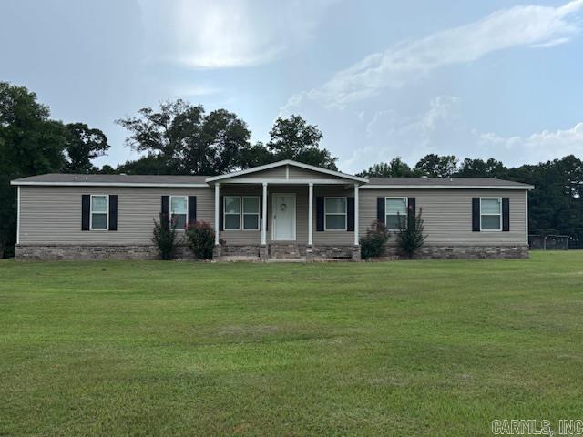 This is a 5 year old manufactured home on three partially fenced acres. It has six (6) bedrooms, three (3) baths, a living room, a dining room/kitchen, a family room, laundry room and has a 8' x 22' porch in the front and a 12' x 54' covered patio at the back. The home is 30' x 76'. There is also a 30' x 30' workshop/garage with an attached 12' x 30' carport.