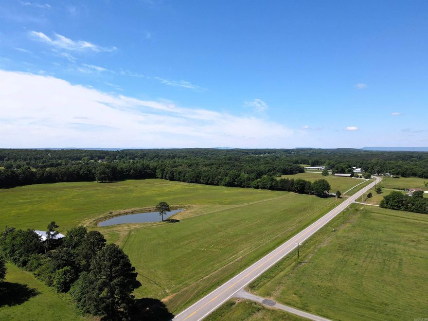 This 1.27 +/- acre tract offers a straightforward path from purchase to building. The land is mostly level, backed by a recent survey, and sits outside the flood plain, giving you confidence in what you’re buying and where you can build. With power and county water available, much of the groundwork is already in place. The highway frontage provides easy access, whether you’re planning a home, shop, hobby farm or small investment project. Minimal restrictions give you the flexibility to make it your own without unnecessary limitations.  Conveniently located just 7 miles to Morrilton and 16 miles to Conway, you’ll have quick access to everyday essentials while still enjoying a quieter setting. The land is being offered as a whole or in 4 equal tracts of 1.27+/- acres at $50,000 per tract. A clean, usable piece of land that’s ready for your next step.