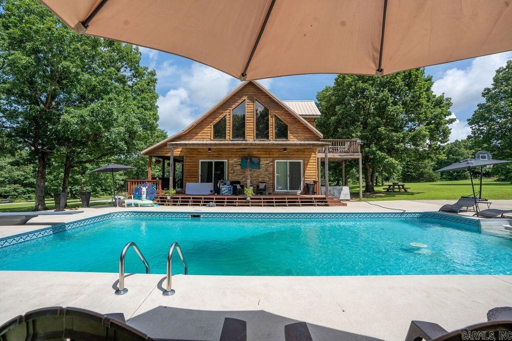 Escape to your own private paradise in Drasco, Arkansas! This stunning 4-bedroom, 2-bathroom home is nestled on 9.33 acres m/l of mostly wooded land with some picturesque pasture, offering both privacy and room to roam. Imagine summer days by your beautiful swimming pool or shooting hoops on your private basketball court - perfect for family fun or unwinding after a long day. With gorgeous aerial views showcasing the serene surroundings, this small-town gem outside the city limits is truly a dream come true. Don't miss the opportunity to make it yours! Schedule your private tour today.