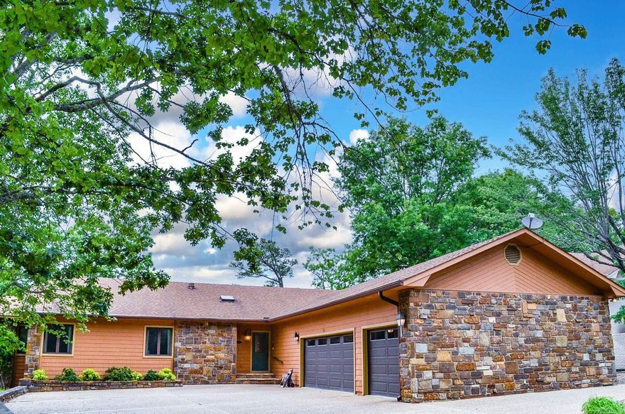Beauty surrounds you.....This custom built Balboa Golf Course home offers nearly 4745 square foot of living area. Expansive deck allows you to enjoy the newly renovated Balboa Golf Course. The home now sets on #14 green and #15 tee box Large living room with native stone fireplace, formal dining area, roomy kitchen with island plus eat-in area and delightful sun room. 3 bedrooms on entry level with huge lower level for entertaining, hobbies or workshop.  Oodles of storage spaces. Recently refreshed landscaping and 3 car garage make this a wonderful location and pretty as a picture exterior. Hot Springs Village Property owner Association has a new member buy-in of $2000.00 due and collected at closing.