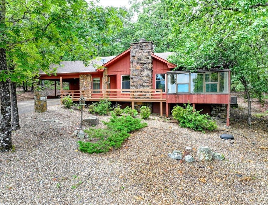 CHARMING RUSTIC HOME ON TOP OF THE MOUNTAIN RIDGE! 3 bed, 2 bath home with NEW HVAC this year and no immediate neighbor on either side. Minutes to Desoto Lake, beach, trails, and Golf Course!   This inviting home features a stone wood-burning fireplace and matching stone exterior details. The spacious living room has vaulted ceilings with wood beams, creating an open, airy feel.  The eat-in kitchen has a large bay window overlooking trees, and a separate dining area flows into the living space, ideal for gatherings. The split bedroom floor plan offers privacy, with the primary bedroom featuring an attached bath.  A highlight of the home is the solarium, overlooking a seasonal mountain top view and providing unobstructed views of nature by day and starry skies at night — perfect as a greenhouse or relaxing retreat.  Enjoy summer grilling on the back patio or coffee on a bistro set on the front deck. Both the front and back of the property feature low-maintenance rock garden landscaping, offering beauty with minimal upkeep.   Would make a great short term rental or a full-time peaceful retreat! COME AND SEE!   Agents - please schedule all showings through Showing service.
