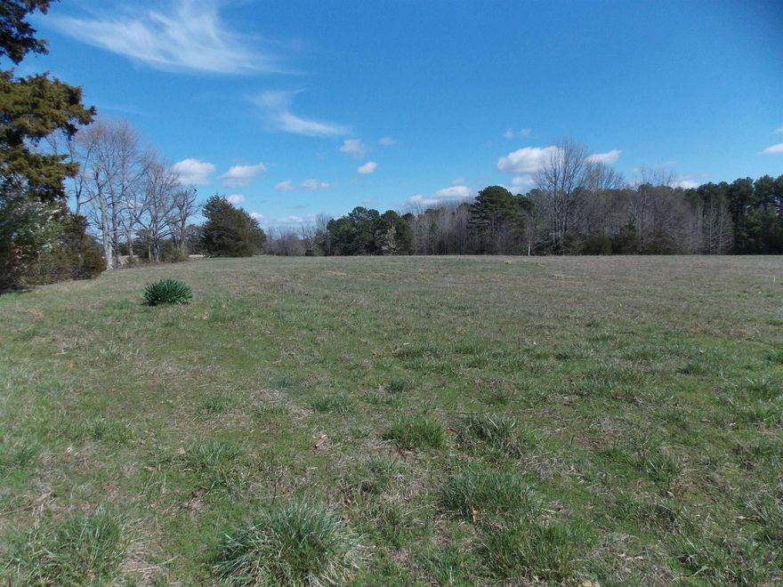 Beautiful old farm home place with nice mixture of pasture and timber w spring fed well. It has paved road frontage on 2 sides.  Utilities have been connected to the property previously.  Fences around the perimeter, hay has been cut by neighbor for many years and shows sign and history of good hunting.  Spring is located on the property and feeds the pond.  Old home is not livable.  Would be a beautiful place to build that dream home.  Natural gas line crosses the property.