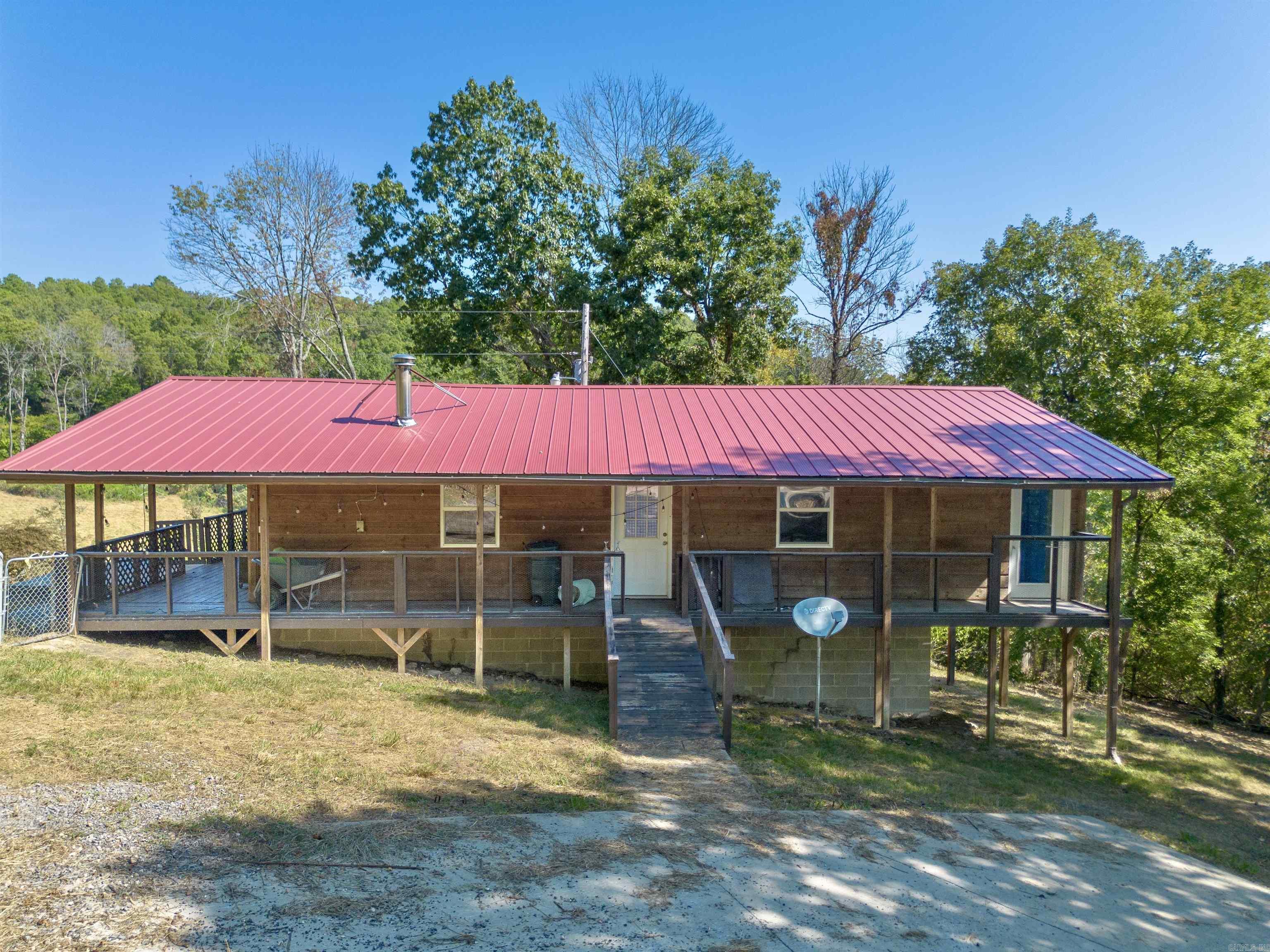 Escape to the Ozarks with this cozy wood cabin on 78.84± acres in Marshall, AR. This one-of-a-kind property offers the perfect blend of rustic charm and modern convenienceāideal for a private retreat, hunting property, weekend escape, or Airbnb investment. Located just over 4 miles from South Maumee Buffalo River access, youāll enjoy endless outdoor adventures like kayaking, hiking, and fishing. The land features a seasonal creek, spring, unique rock formations, and scenic bluffs. Cleared pasture is perfect for livestock or hunting, and numerous trails offer space to explore. Inside the cabin, youāll find an open-concept living area with a cozy wood-burning stove and plenty of space to relax. Fiber optic internet brings high-speed connectivity, and a third bedroom or office with large windows captures stunning views of the natural surroundings. Don't miss this rare opportunity to own a peaceful retreat in the heart of the Ozarks!