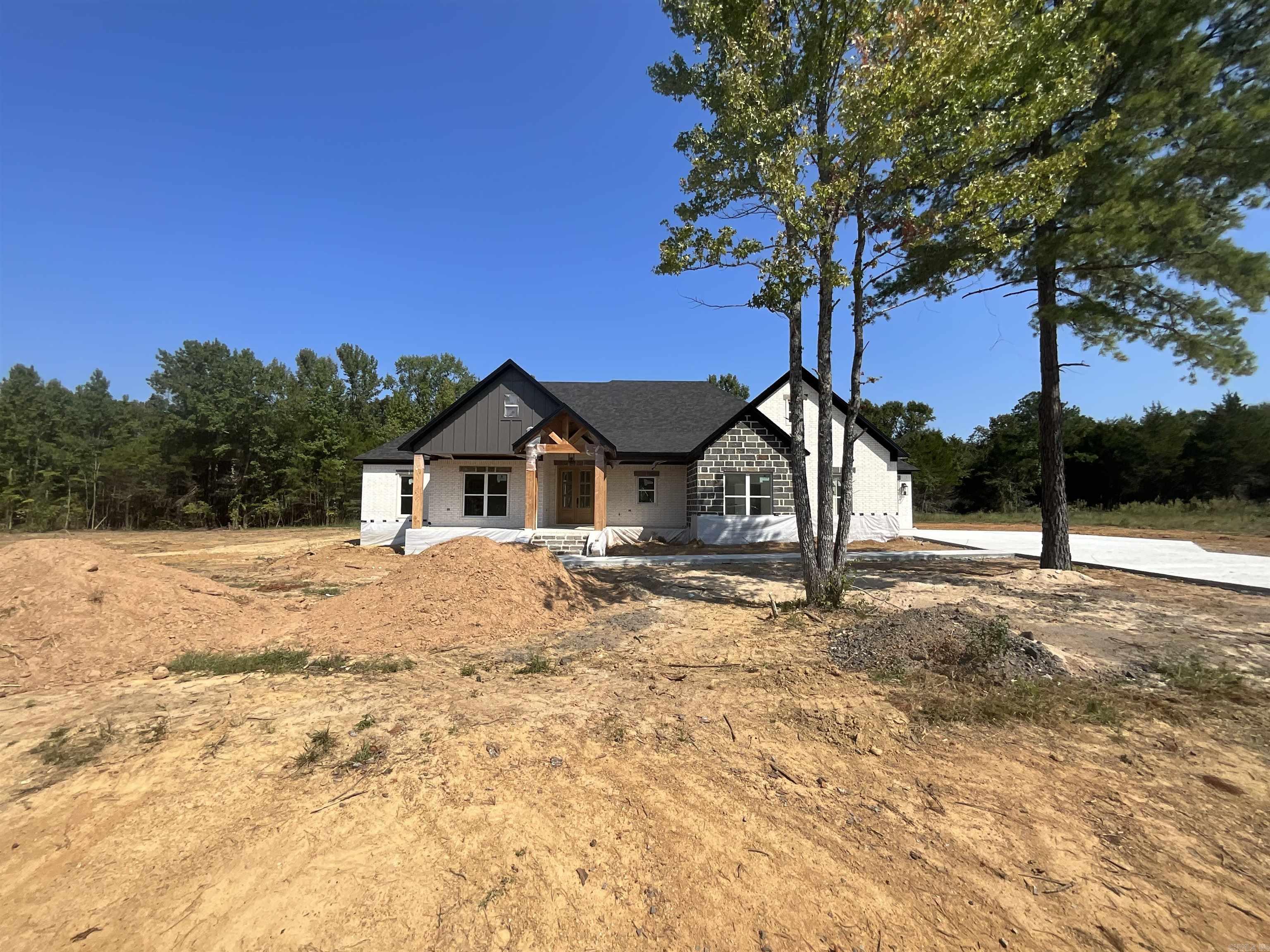 Beautiful new construction home in one of Greenbrier's newest subdivisions conveniently located off of Hwy 225. Enjoy high speed fiber internet here! Huge living room with an electric fireplace. You will fall in love with the large vaulted windows overlooking the private backyard. The kitchen is a dream with expansive countertops, plenty of cabinets and the amazing hidden pantry. The laundry room joins the primary closet which circles through to the primary bathroom. In the primary bath is a custom tile shower, soaking tub and dual vanities. Lockers located as you come in from the garage with lots of extra storage. Luxury vinyl flooring throughout with granite countertops in kitchen and bathrooms. 3 car garage Come see this home today! There are other homes under construction and for sale in this new phase of Coyote Ridge sub.