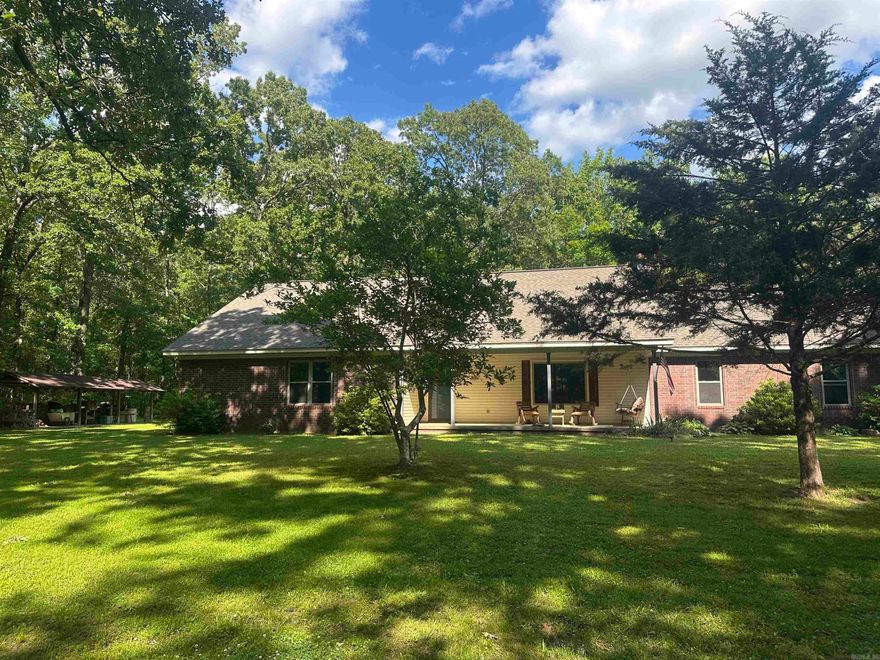 Custom home built in the midst of a vast of trees for your own oasis!  Cascading driveway that you can just imagine Hansel & Gretel skipping along with their bread crumbs! 20x24 shop with lean to for all the outside toys! Home is so welcoming with huge living area and new windows to capture the essence of the country.  Wood burning fireplace for cozy winters. Primary bedroom can absorb more furnishings and an office space. Bathroom has been totally remodeled 8 yrs ago and hall bath has been updated as well.  New roof in 2019, new HVAC 2018, HWH 2004, new dishwasher 2023 and brand new stove this year. The covered back porch and swing invites you to enjoy the calmness of nature.  Garden space and wildlife to entertain you!