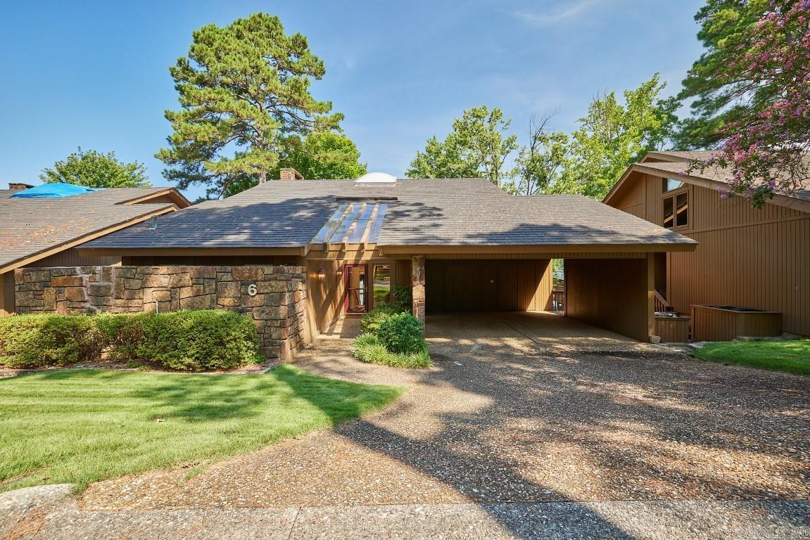 WestRidge - a gated enclave of tree-shaded homes on the shores of Lake Hamilton. The popular area feels like the country, although only a few minutes from shopping and city conveniences. This 3 bedroom, 2.5 bath home is now available for a new owner! Features include: A private, covered single stall boat dock. Each bedroom has its own deck access. Large kitchen with breakfast bar. Parking for several vehicles. Sparkling swimming pool. Onsite property manager. Split level floor plan, primary suite on main level. Lots of storage inside and outside.