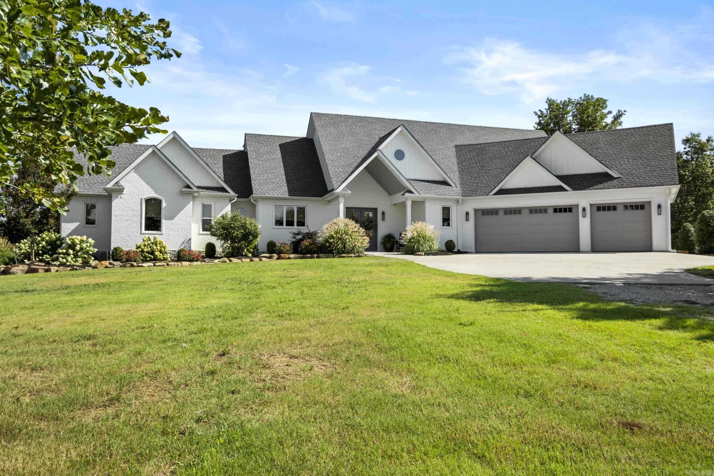 Custom built home w/premium amenities throughout. Open floor plan provides easy flow from kitchen / dining to the living area which offers a cozy gas fireplace flanked by built ins. Office area off the living room. Half bath main level. Gourmet kitchen features quartz countertops, double ovens, six top gas burner stove, farmhouse sink, undercounter microwave & the island is a chef's dream. Living area has lots of windows & 3 sets of French doors leading to the outdoor entertaining area complete with views of the pond. Surround sound system from inside the home and out to the large covered patio. Primary suite features a walk in closet w/built ins including a vanity area. Oversized walk in shower in primary suite plus soaking tub complete this deluxe suite. Safe room located on main level in the guest room which has ensuite bath. Sprinkler system. The shop is an outdoor enthusiast's dream with Over 3900 sq ft. Roll up doors on each end. W/D hookup. Half bath. Cedar closet. Lofts w/stairs on each side. Two storage rooms (could be office). Lean to on each side. RV hookup outside shop. 20 acres is apprx 1/4 timber covered.