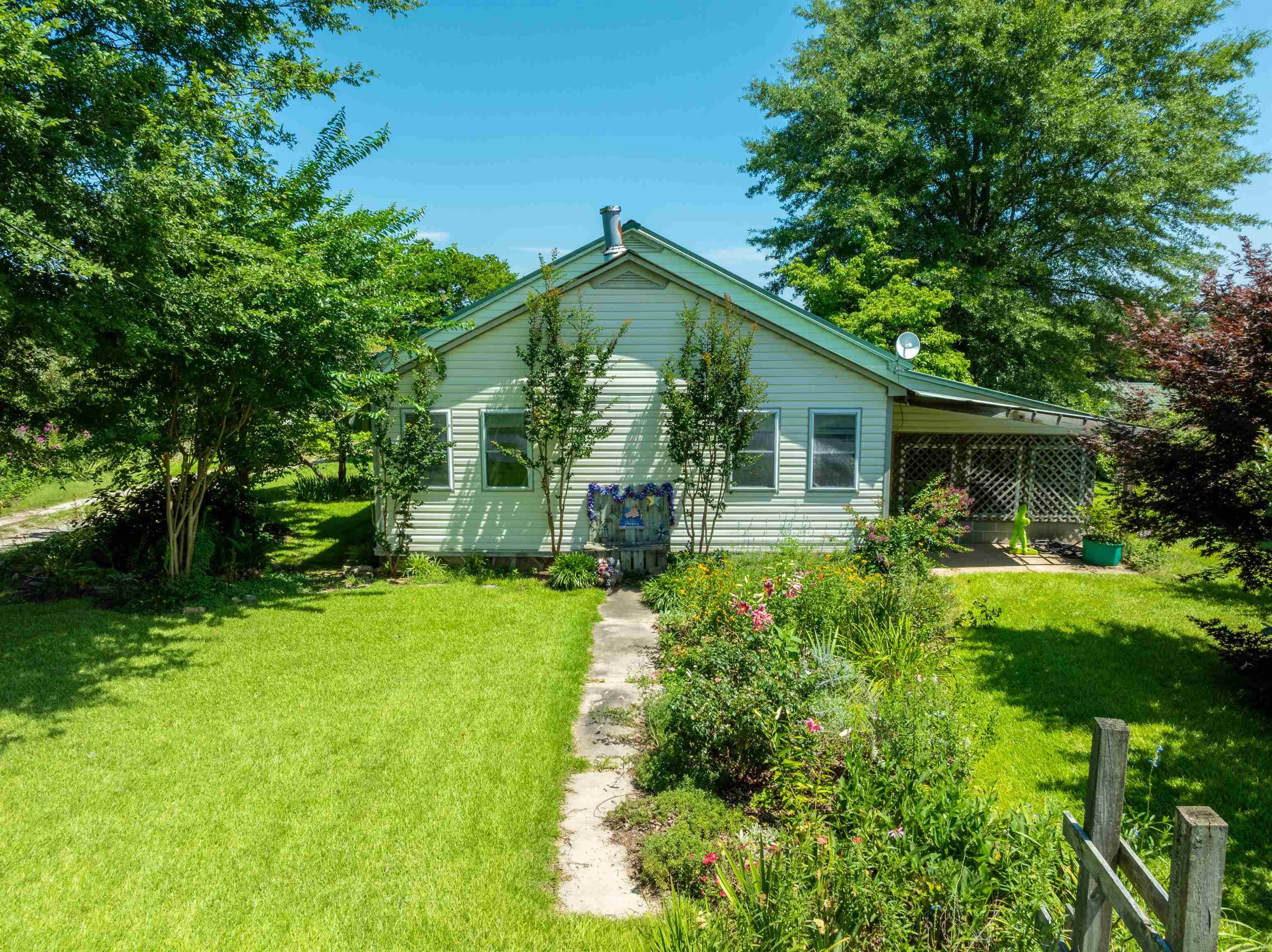 Country Home with Barn, Chicken Coop & Pond on 10± Acres ā Bethesda, AR Welcome to 550 Medlock Road in Independence County, located just outside Batesville in the quiet community of Bethesda. This charming 2 bed, 1 bath country home sits on 10± acres and offers the perfect setup for a mini-farm or peaceful rural lifestyle. The home features a newly updated kitchen with custom wood cabinets, heart pine floors, a restored vintage tub with shower, and multiple heat sources including central HVAC, propane, and a wood stove. An enclosed sun porch offers a bonus living space and could easily serve as a 3rd bedroom or sitting area. The land is fenced and cleared with plenty of room for livestock or gardening. Outbuildings include a 30x33 barn with stalls, a 14x40 chicken house, detached garage, carport, greenhouse, tool room, and even a historic WPA-built outdoor toilet. Water is abundant with city water, two wells, two cisterns, and a pond thatās never gone dry (per seller). Raised garden beds, fruit trees, and beautiful landscaping complete this functional homestead.